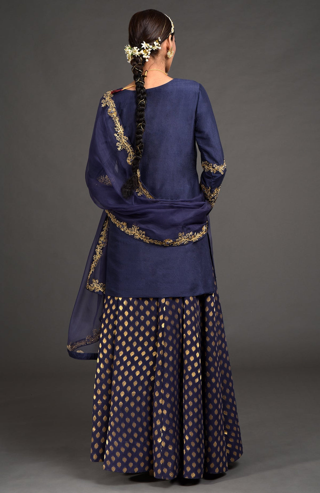 Eclipse blue lehenga set with gold zardozi embroidery on kurta, dupatta, and skirt panels.