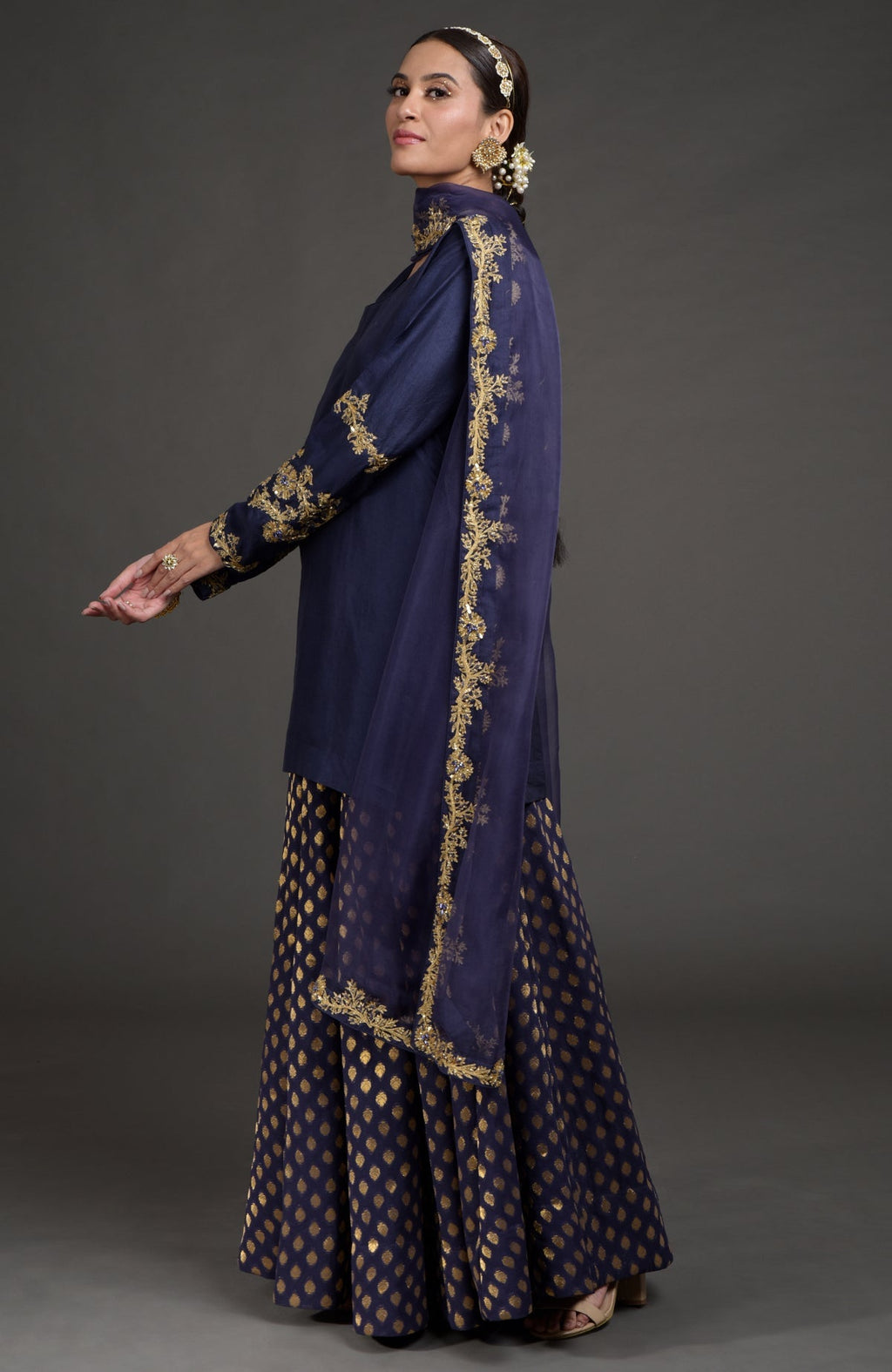 Eclipse blue lehenga set with gold zardozi embroidery on tunic, dupatta, and skirt panels.