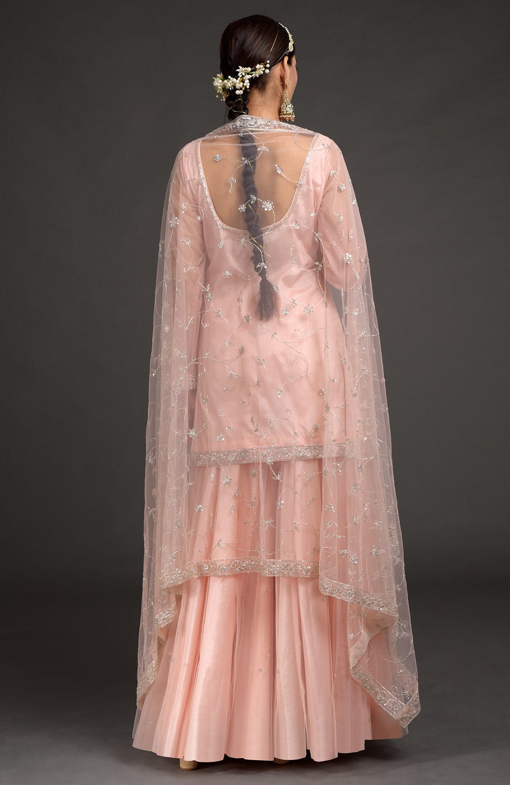 Nude pink tulle sharara set with zardozi embroidery and sheer sleeves with floral dupatta.