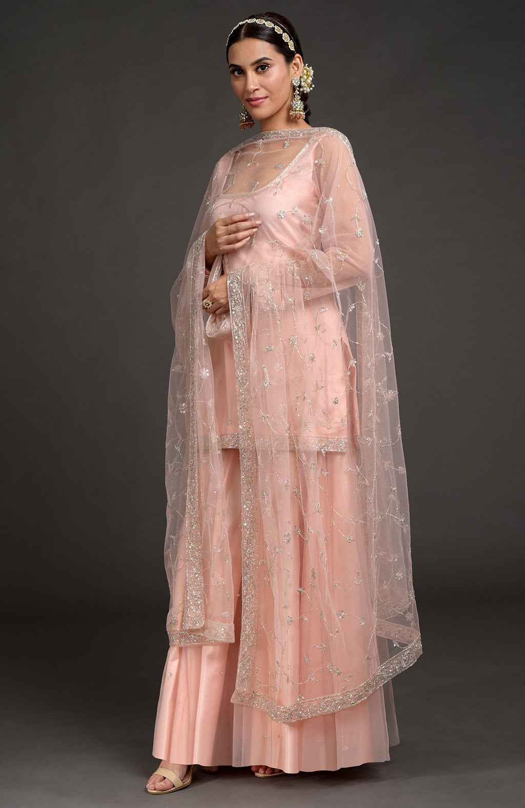 Nude pink tulle sharara set with zardozi embroidery on kurta, sleeves, and flared pants.