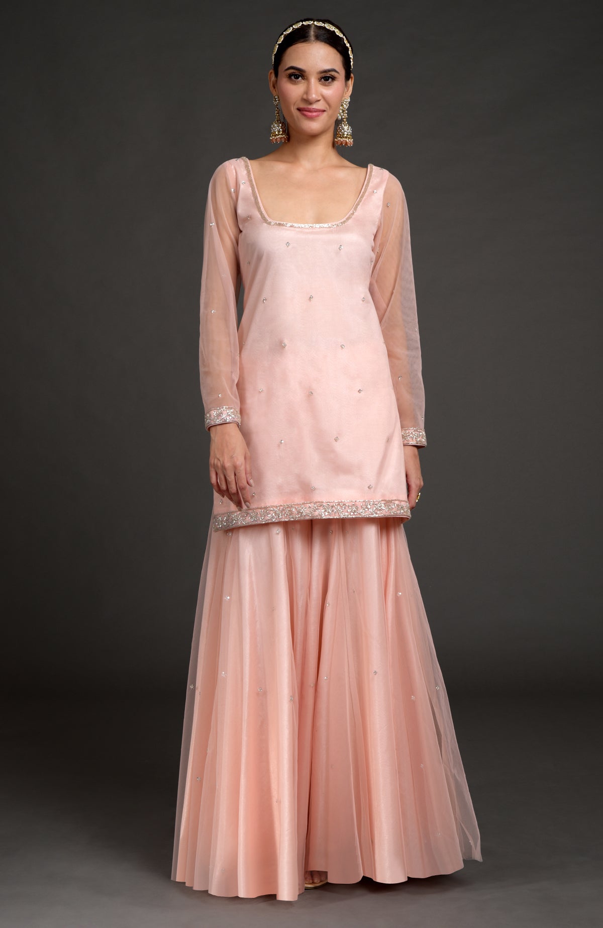 Nude pink tulle sharara set with zardozi embroidery on kurta, sleeves, and flared pants.
