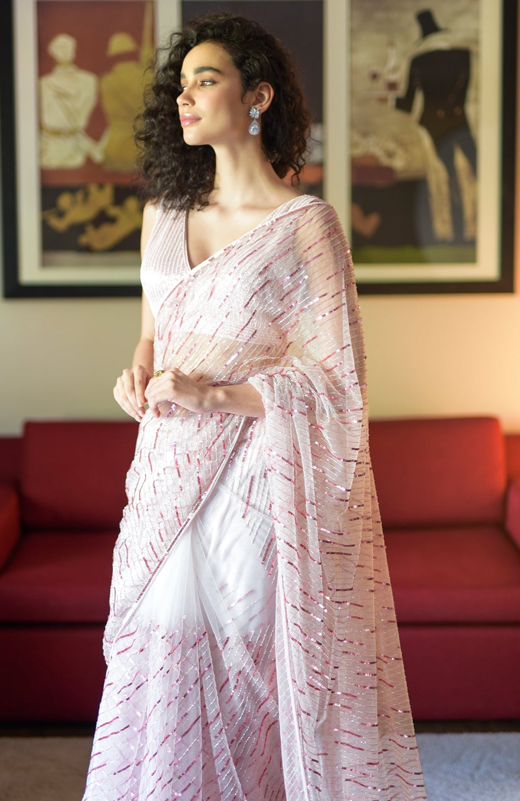 Pink saree with hand-embroidered sequins, beads, and matching blouse with V-neckline.