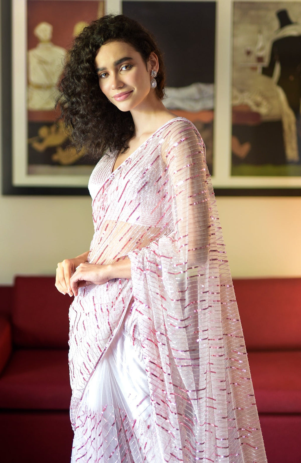 Pink saree with hand-embroidered sequins, beads, and a matching blouse with V-neckline