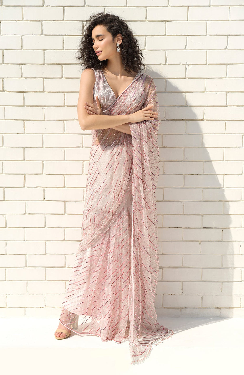 Pink saree with hand-embroidered sequins, beads, and a matching blouse with V-neck design