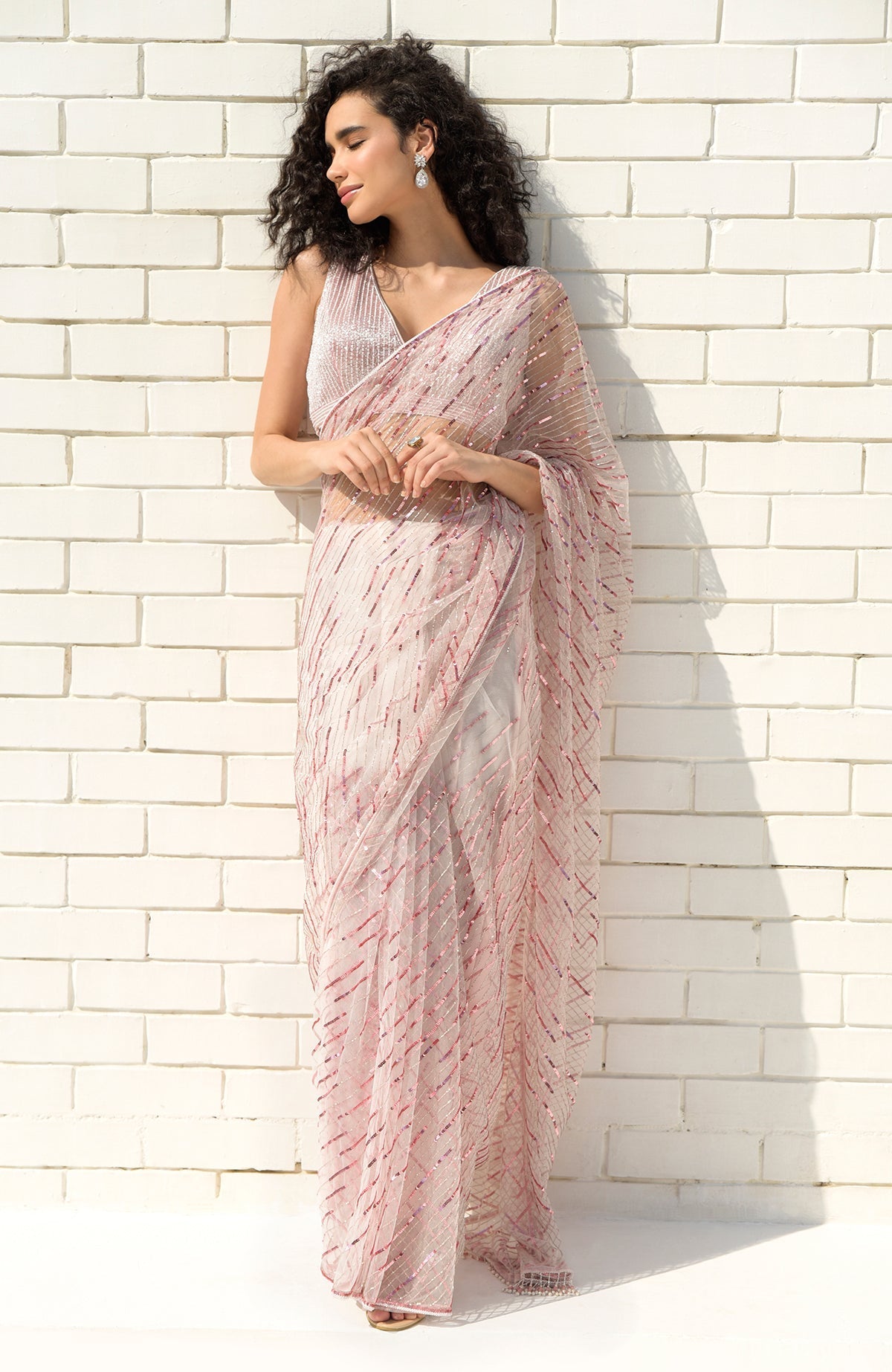 Pink hand-embroidered saree with sequins, beads, and a matching blouse with V-neckline.