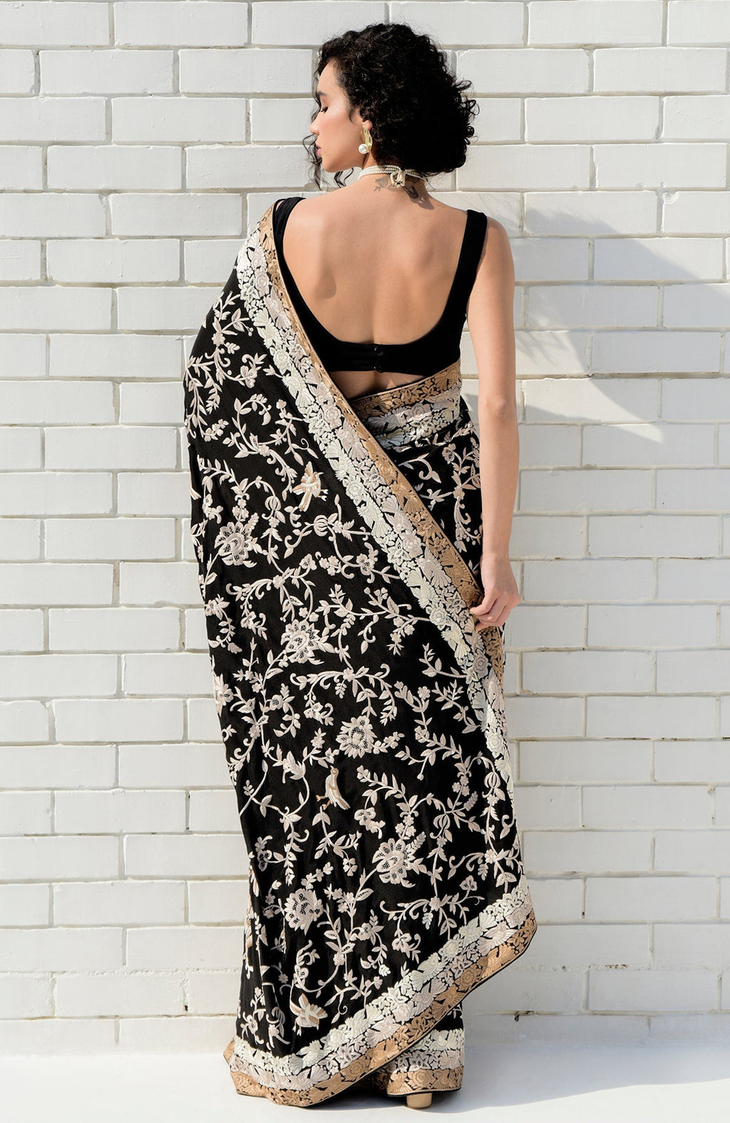 Black saree with hand embroidered Parsi Gara motifs and three tier border in pearl and beige tones