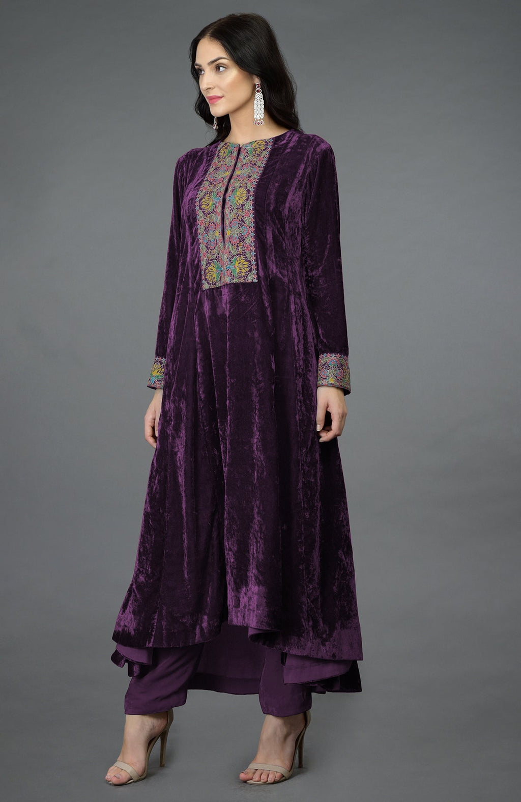 Plum purple silk velvet kalidaar kurta with hand embroidered Kashmiri floral patterns and asymmetrical hem.