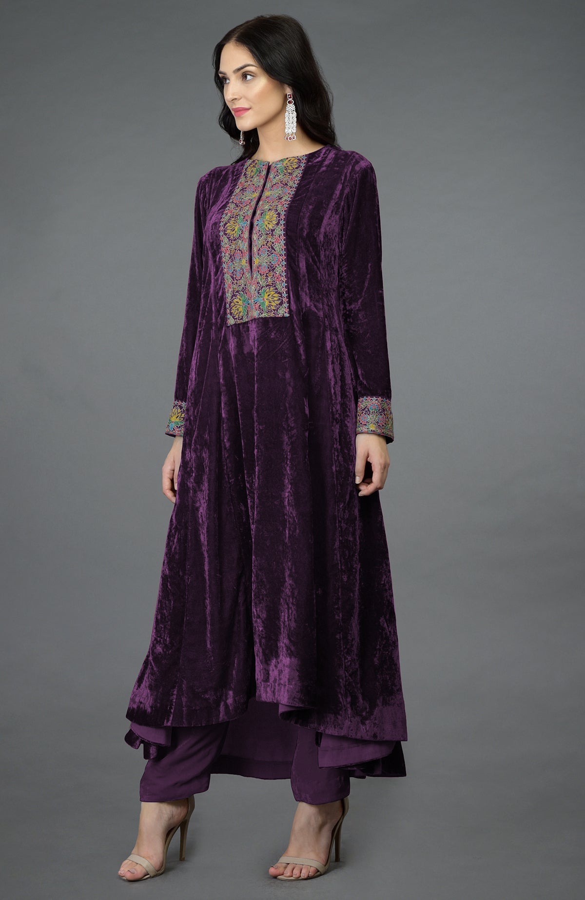 Plum purple silk velvet kalidaar kurta with hand embroidered Kashmiri floral patterns and asymmetrical hem.