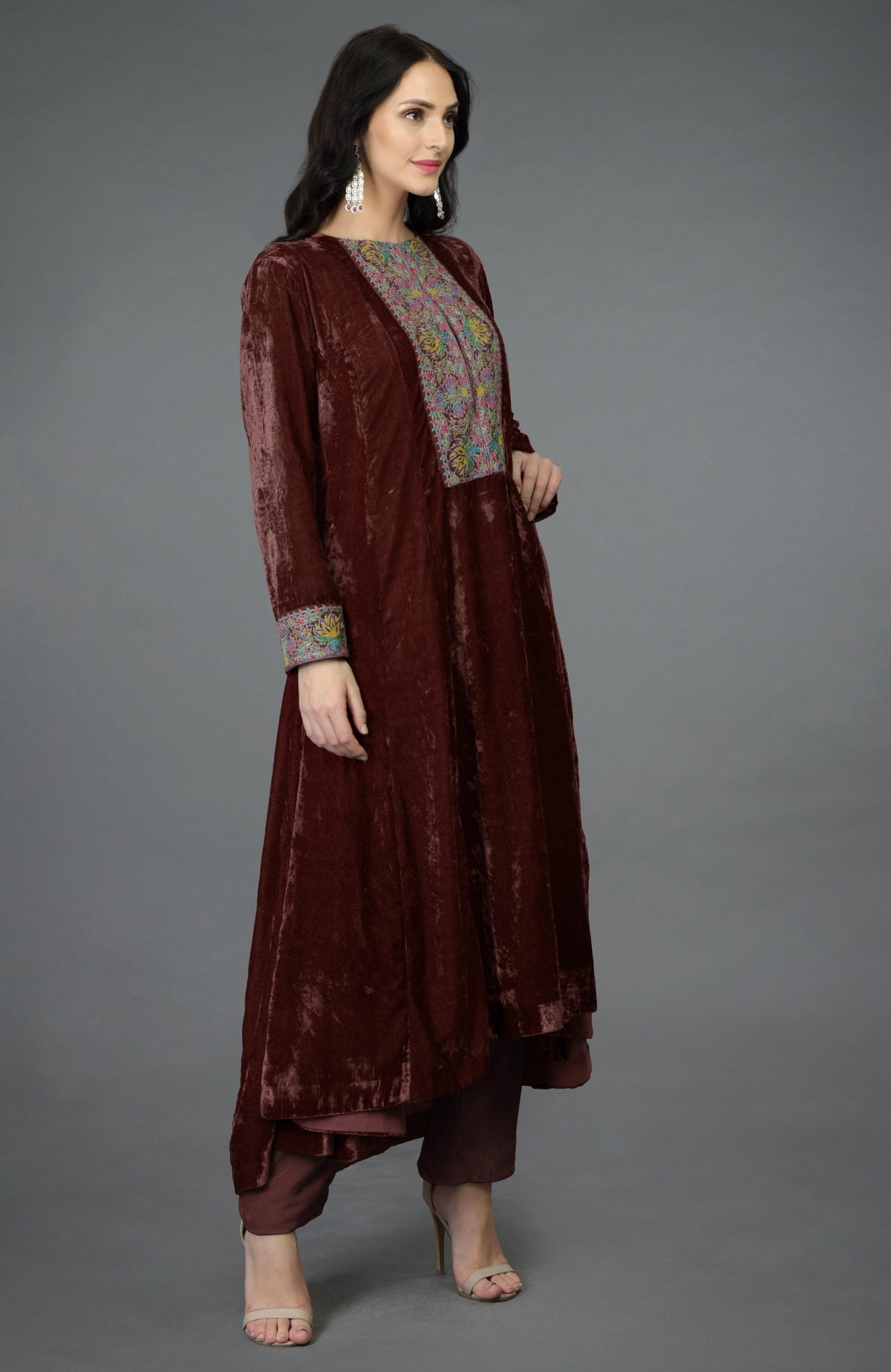 Cabernet silk velvet kalidaar kurta with asymmetrical hem and colorful Kashmiri hand embroidery.
