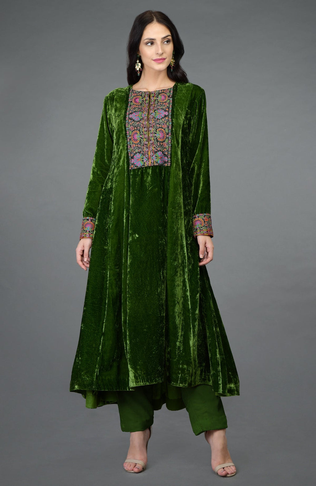 Green silk velvet kurta with asymmetrical hem and colorful Kashmiri hand embroidery on neckline and sleeves