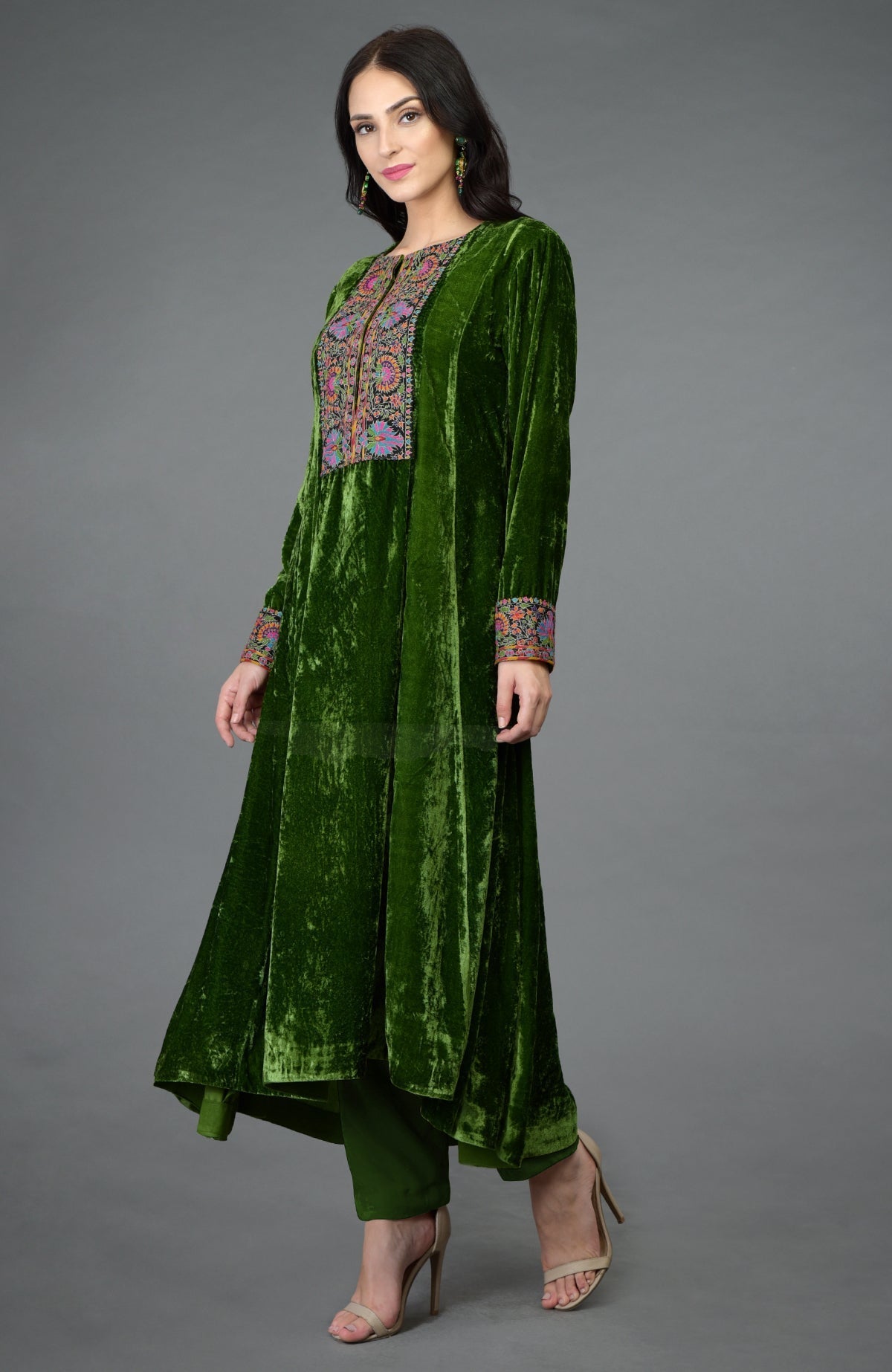 Green silk velvet kurta with asymmetrical hem and colorful Kashmiri hand embroidery on neckline and sleeves