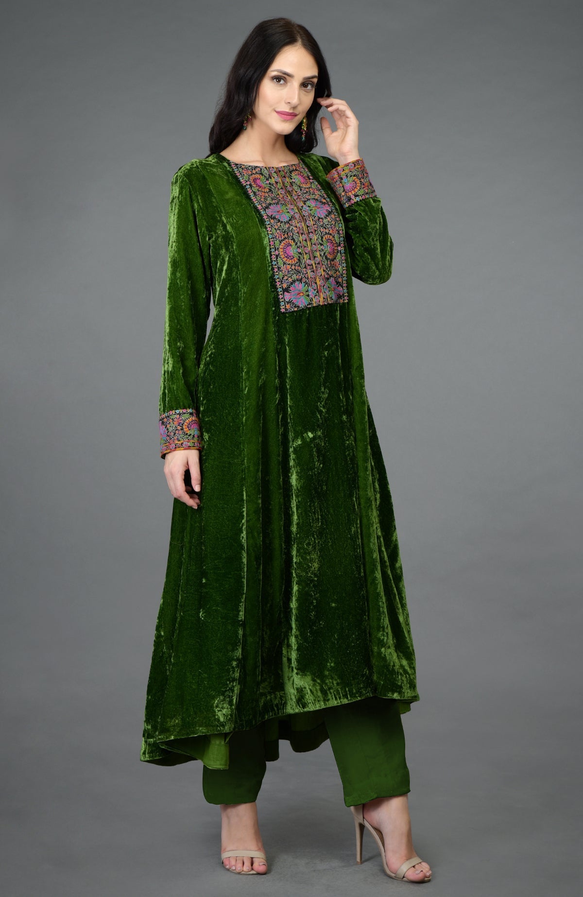 Green silk velvet kurta with asymmetrical hem and colorful Kashmiri hand embroidery on neckline and sleeves