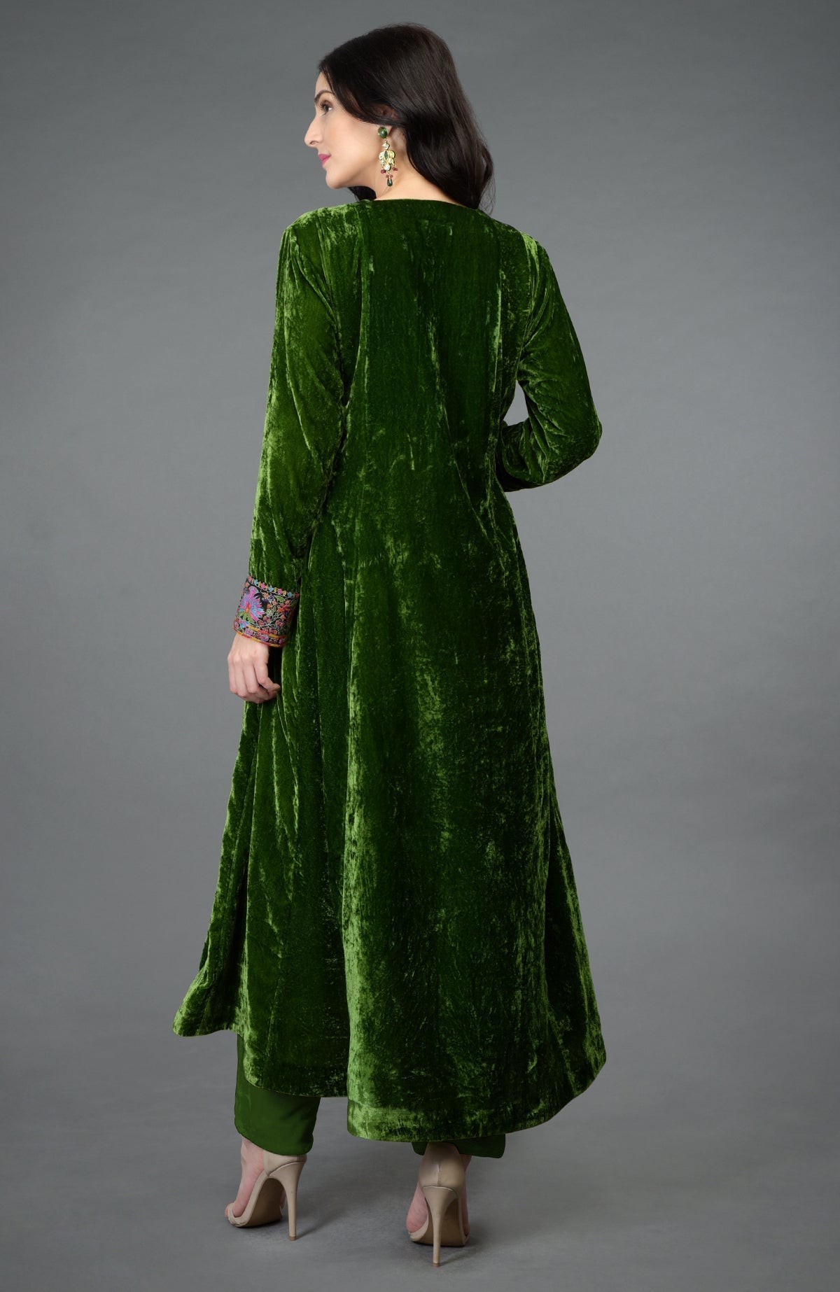 Green silk velvet kurta with asymmetrical hem and colorful Kashmiri hand embroidery on neckline and sleeves