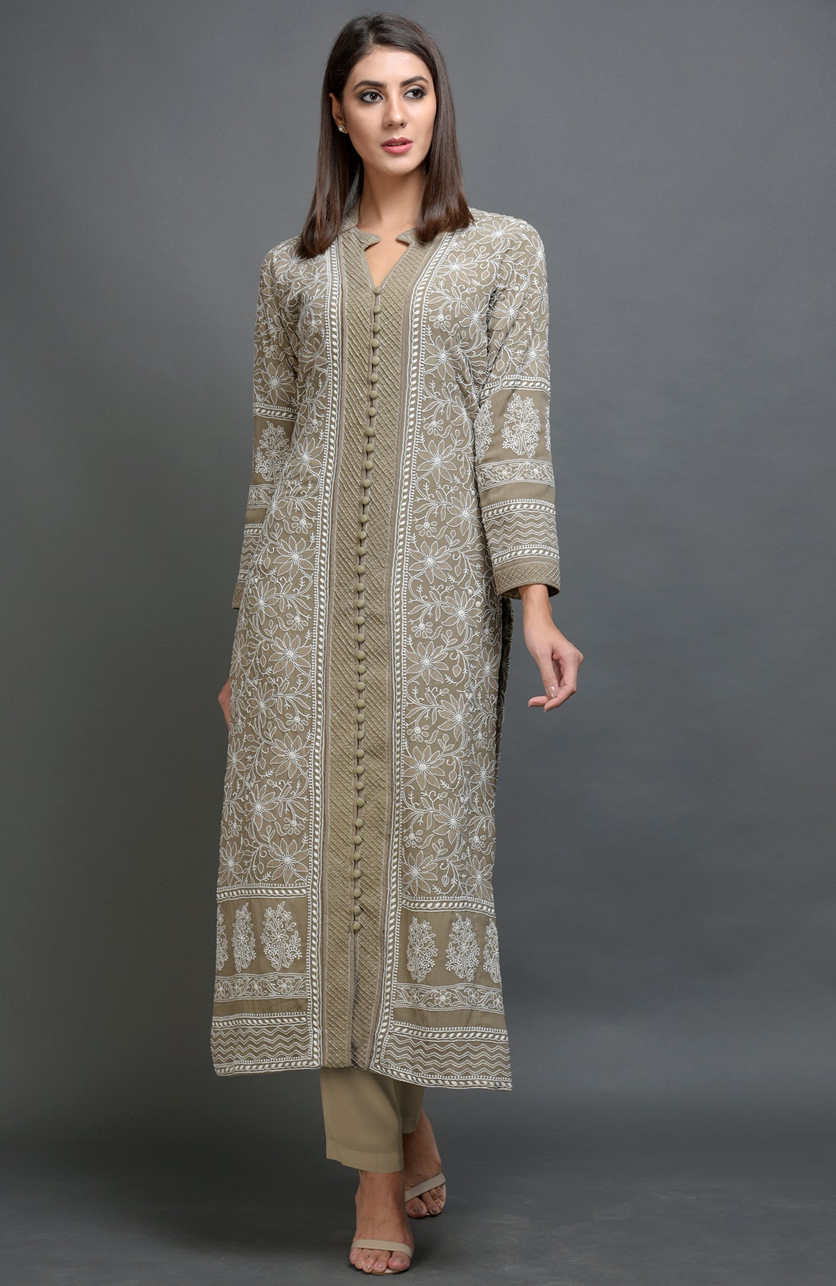 Beige chikankari embroidered jacket with notch collar and matching beige lowers.