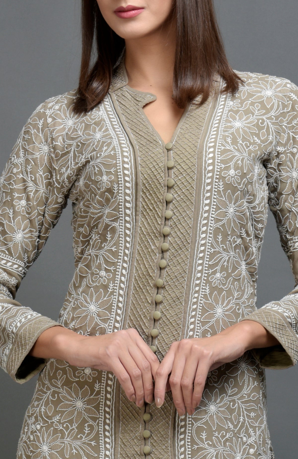 Beige chikankari embroidered jacket with notch collar and matching beige lowers.