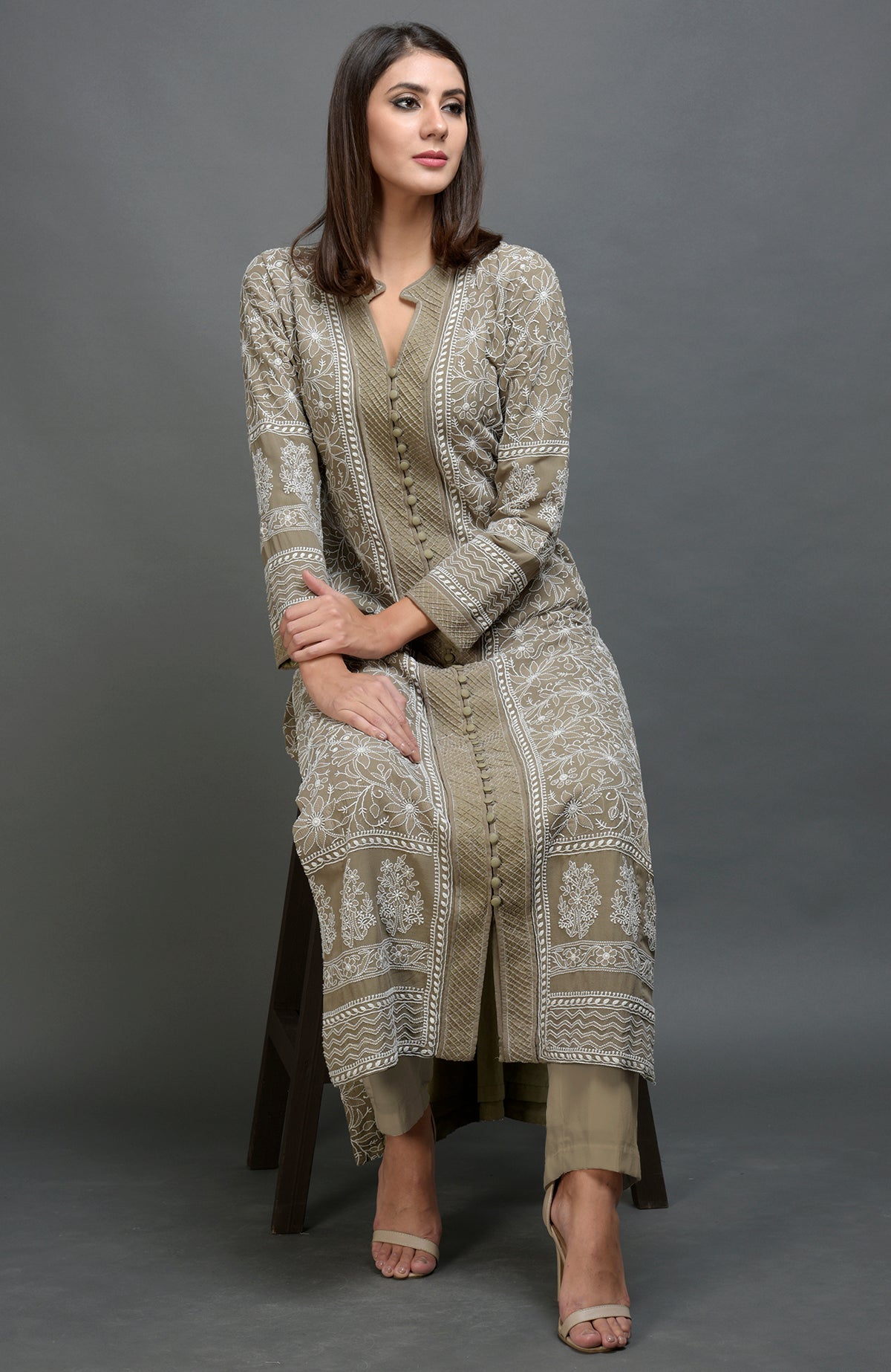 Beige jacket set with intricate chikankari embroidery, notch collar, and matching beige pants.