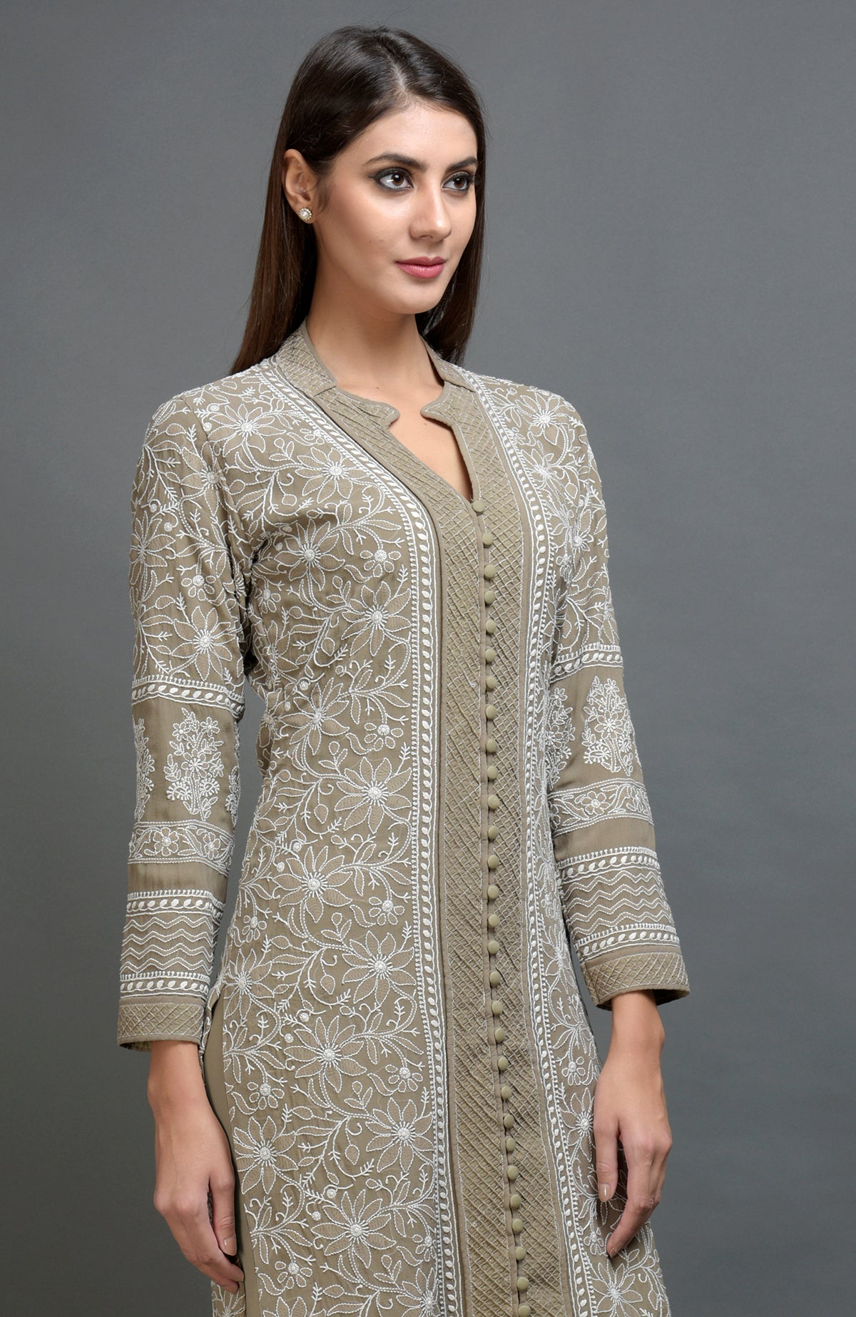 Beige chikankari embroidered jacket with notch collar and matching beige lowers.