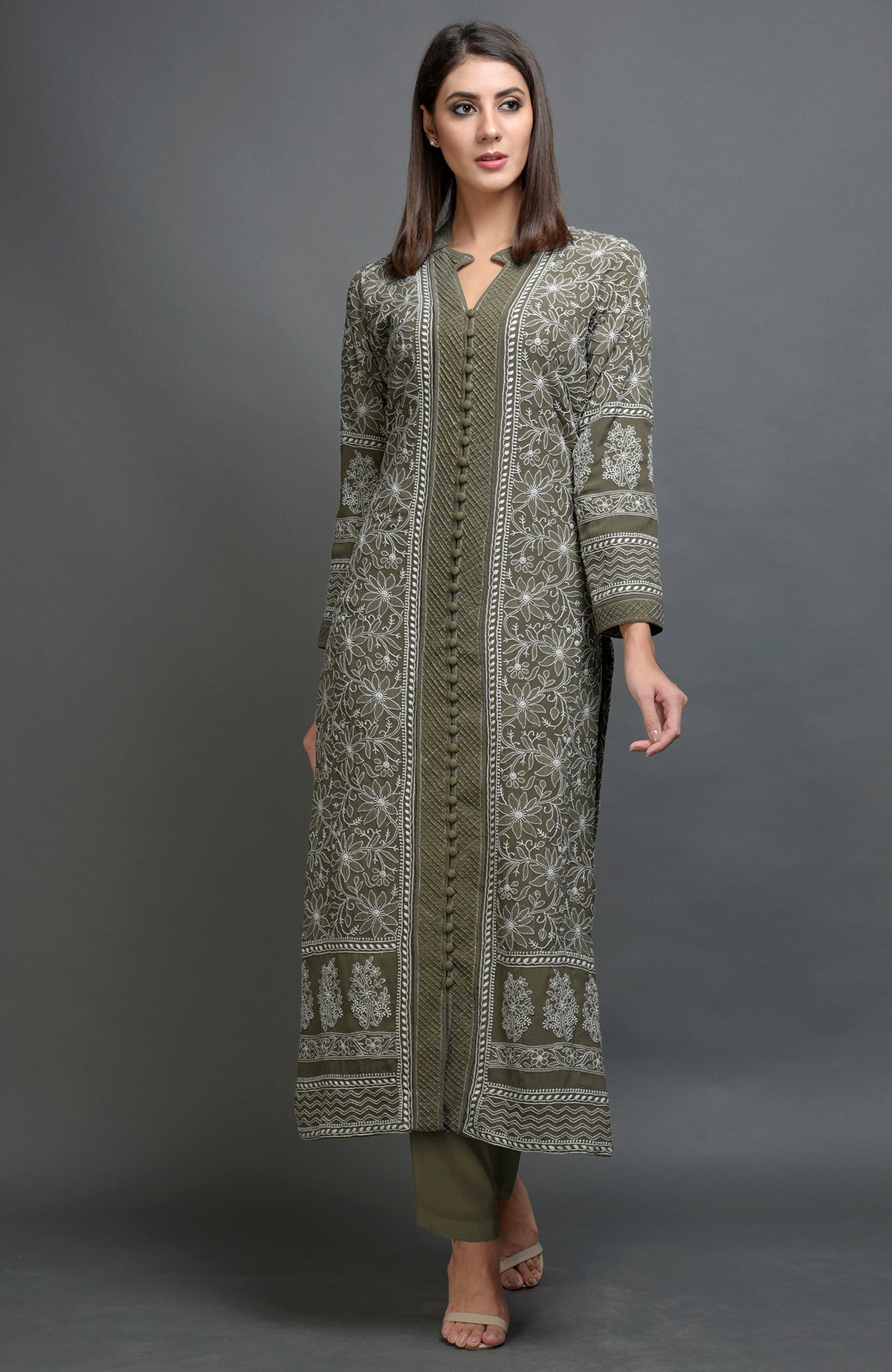 Beige chikankari embroidered jacket with notch collar and matching beige lowers.