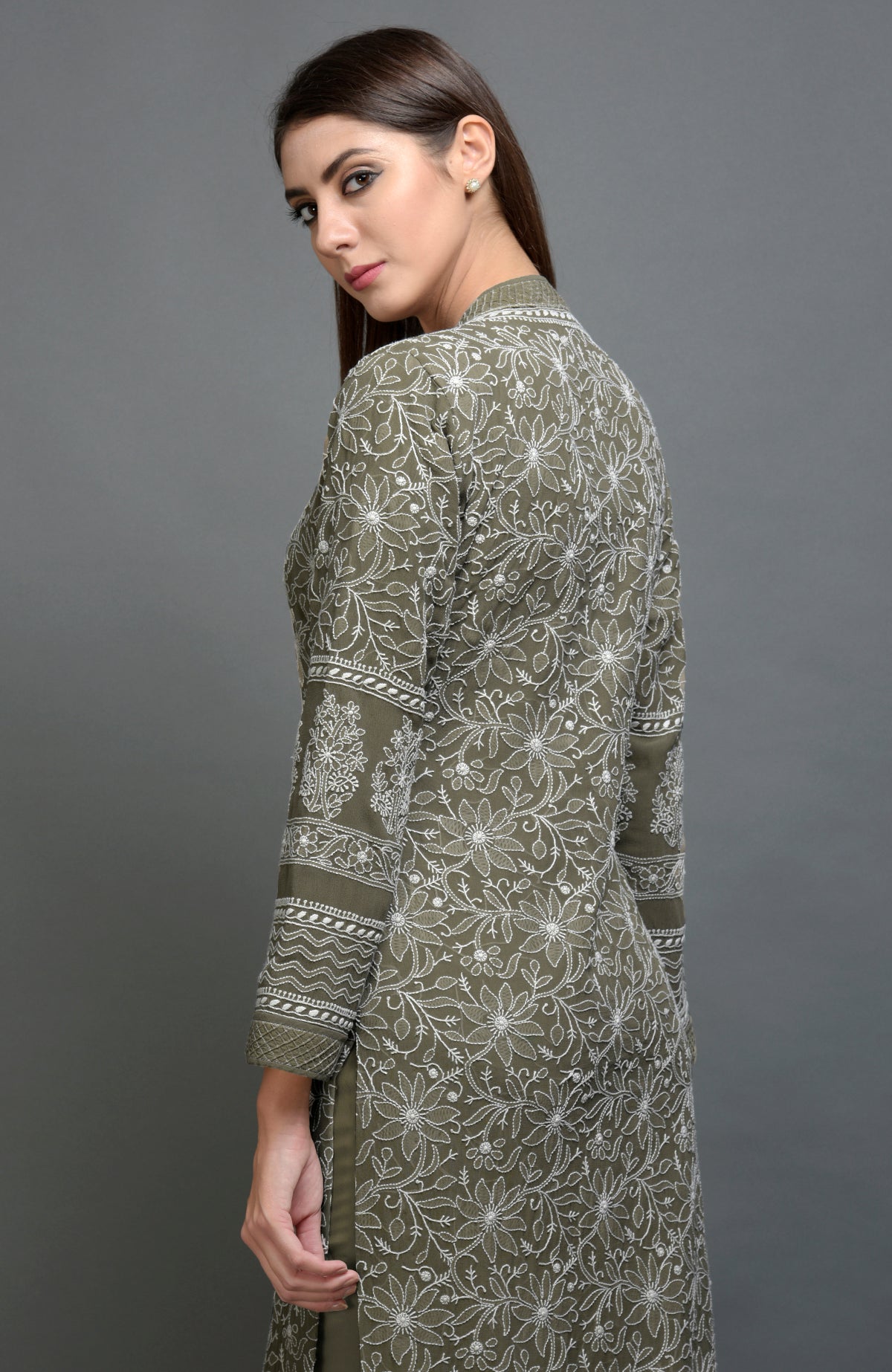 Olive green jacket with intricate chikankari embroidery and matching olive green pants.