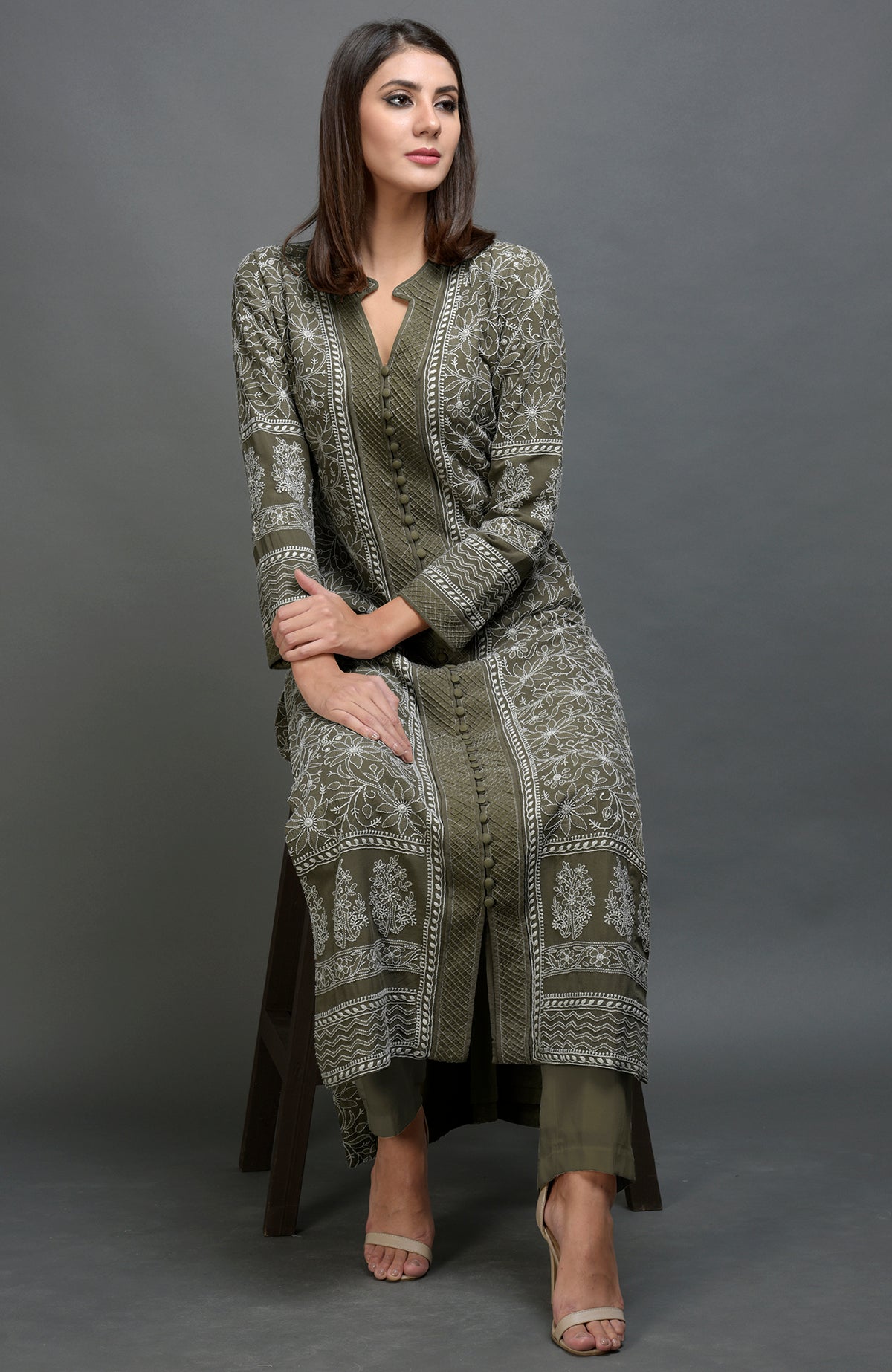 Olive green chikankari embroidered jacket with notch collar and matching olive green pants.