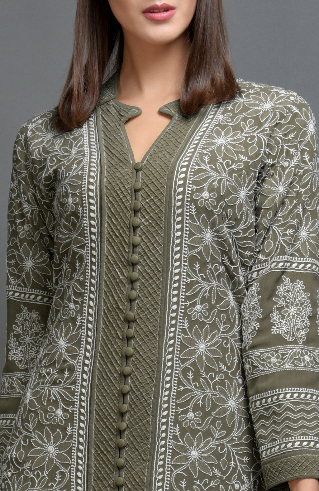 Olive green chikankari embroidered jacket with notch collar and matching olive green pants.