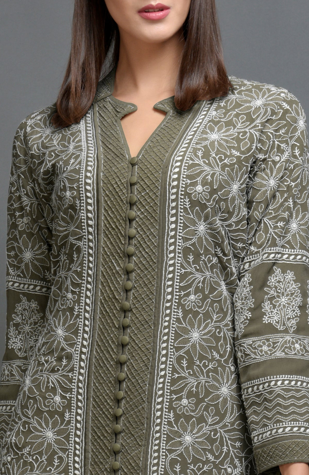Olive green chikankari embroidered jacket with notch collar and matching olive green pants.
