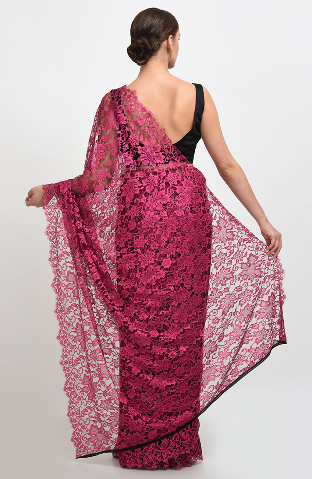 Raspberry saree made of French Chantilly Lace with matching satin blouse fabric visible.