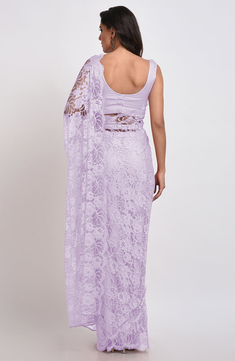 A woman models a lavender fog Chantilly lace saree set from the back.