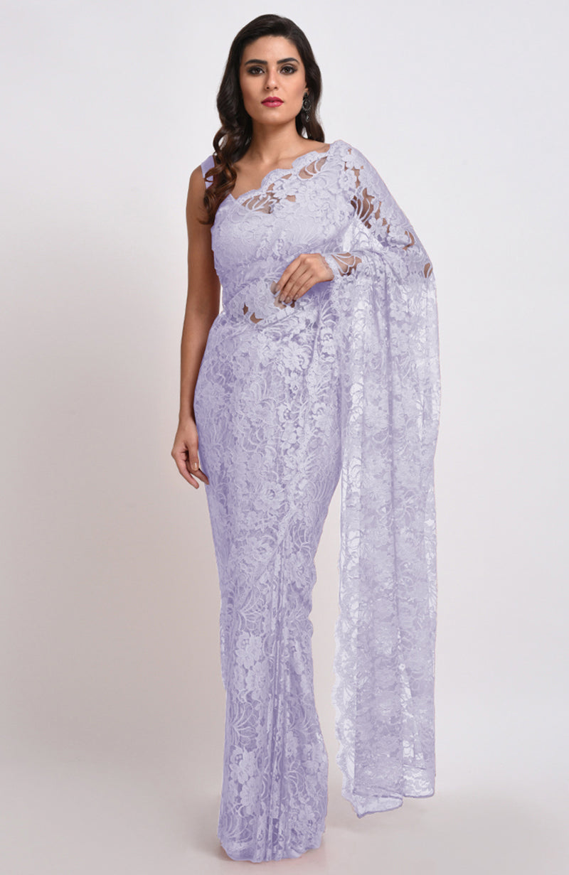 A woman models a light lilac Chantilly lace saree.
