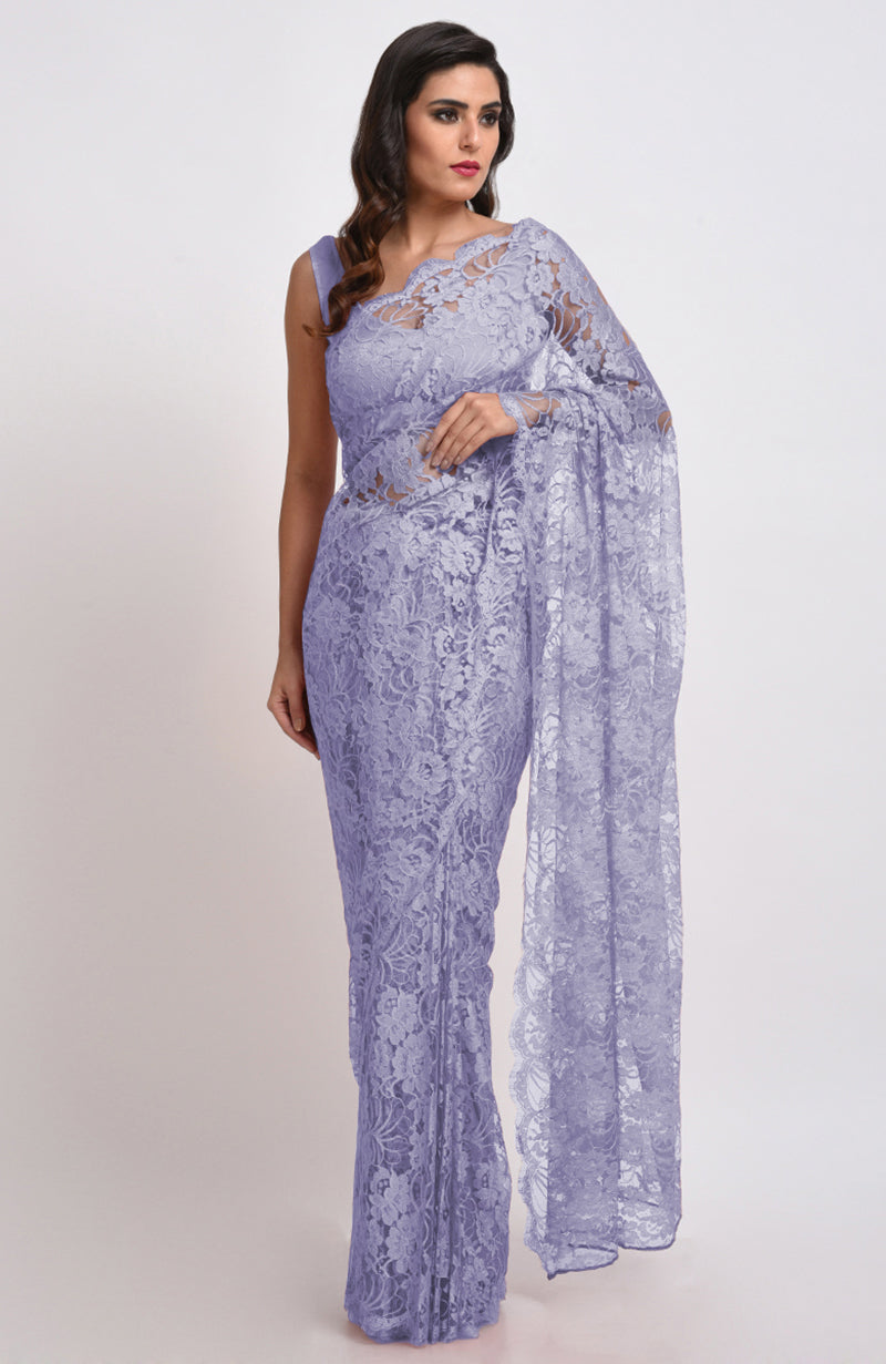 A woman models a light purple Chantilly lace saree.
