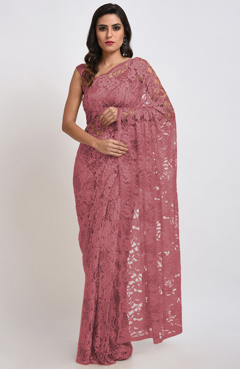 A woman models a mauve Chantilly lace saree with a matching blouse.
