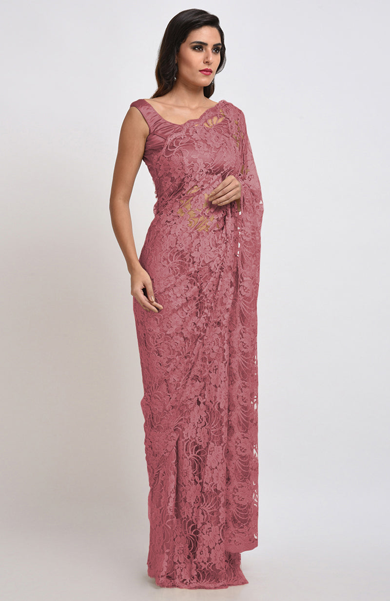 A woman models a mauve Chantilly lace saree with a matching blouse.
