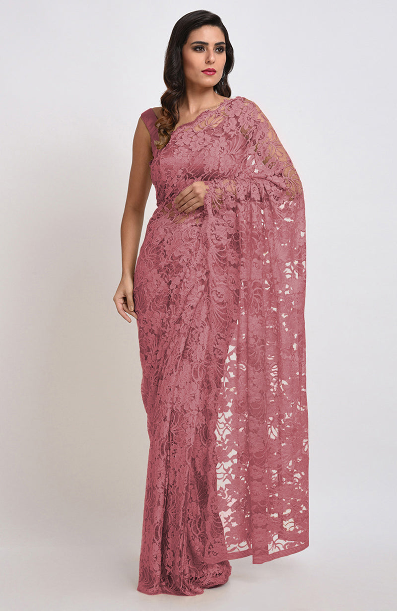 A woman models a mauve Chantilly lace saree.