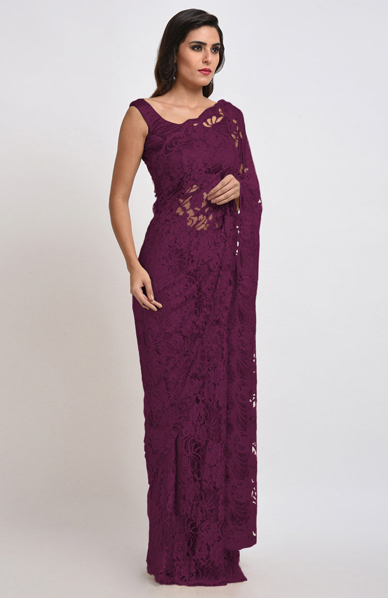 A woman models a wine-colored Chantilly lace saree with a matching blouse.