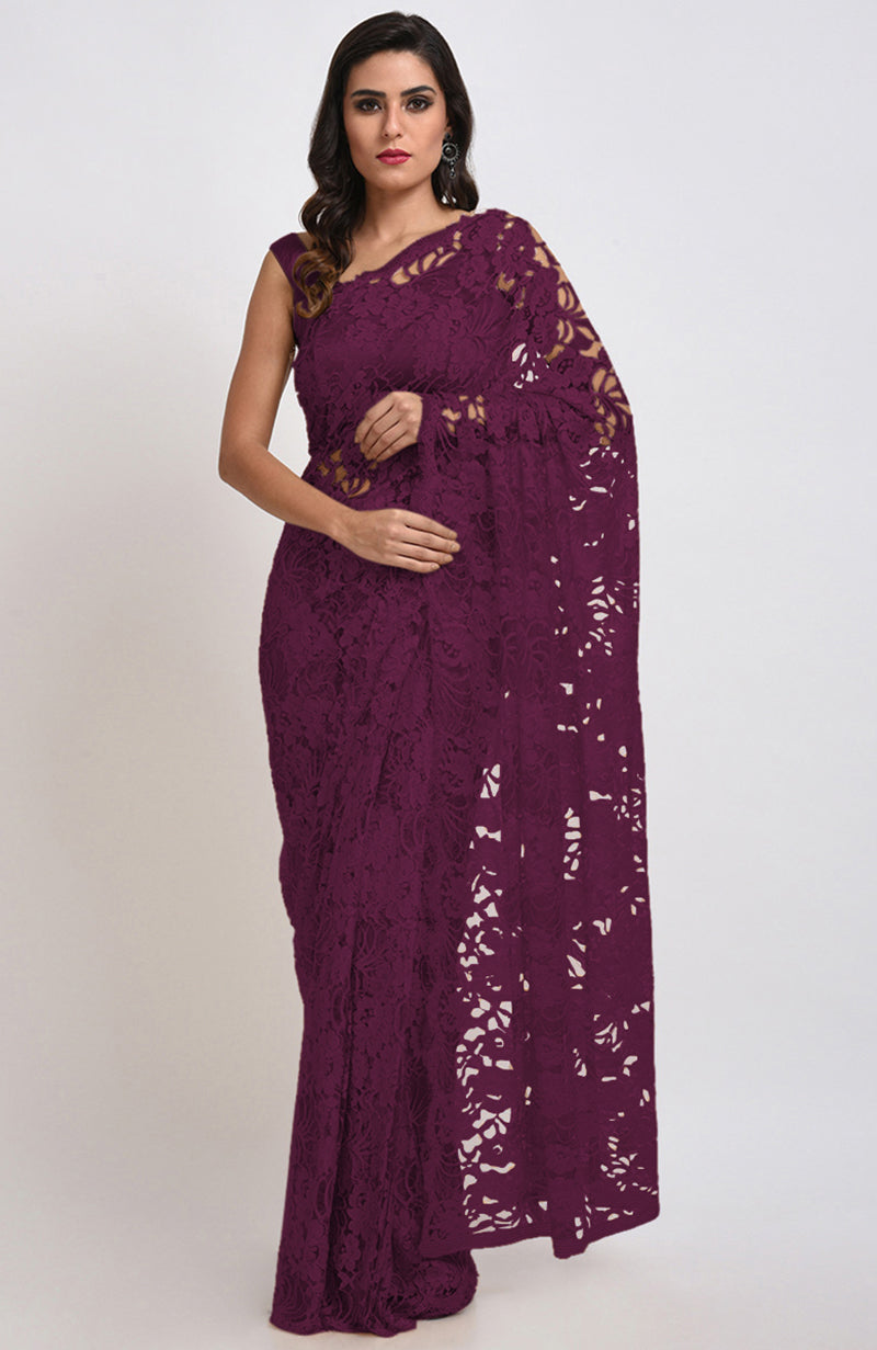 A woman models a wine Chantilly lace saree with a matching blouse.