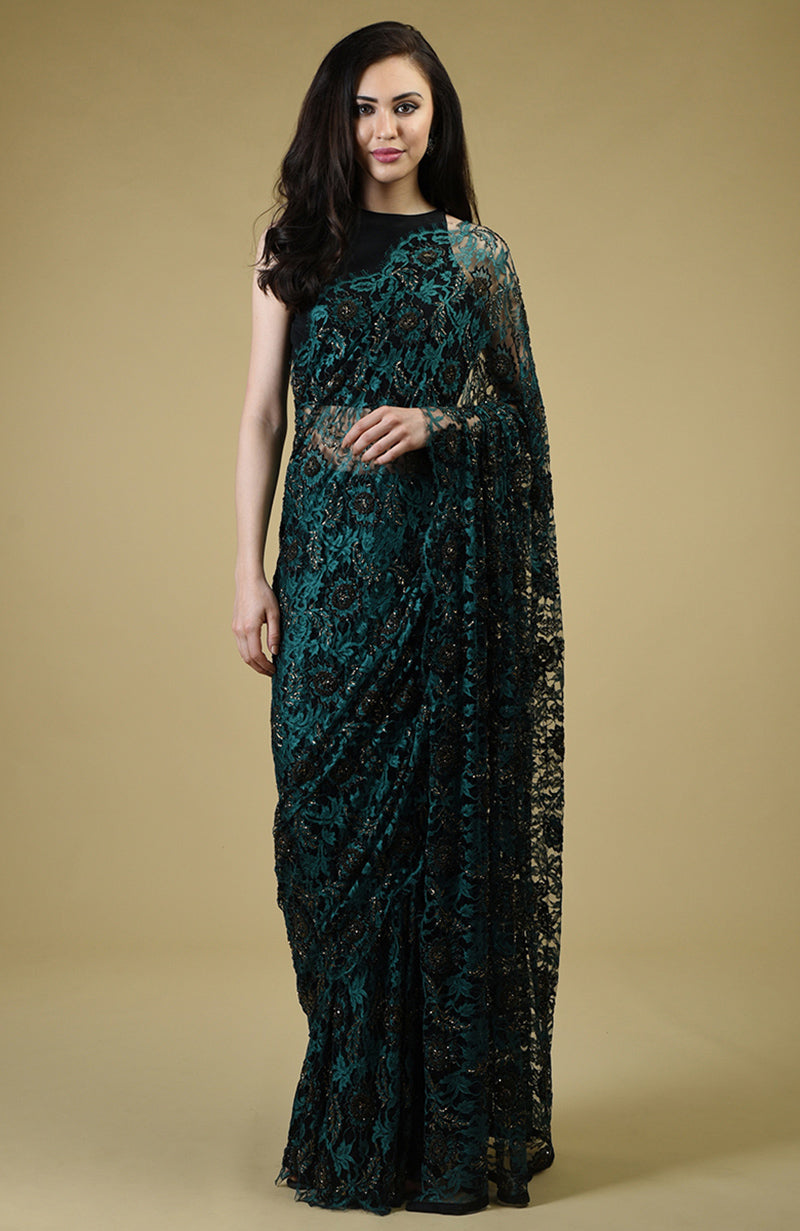 Peacock green French Chantilly lace saree with black and gold bead embroidery and matching blouse fabric