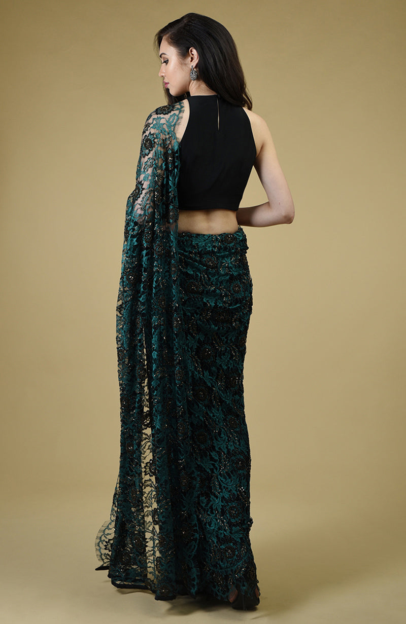 Peacock green French Chantilly lace saree with black and gold bead embroidery and matching blouse fabric