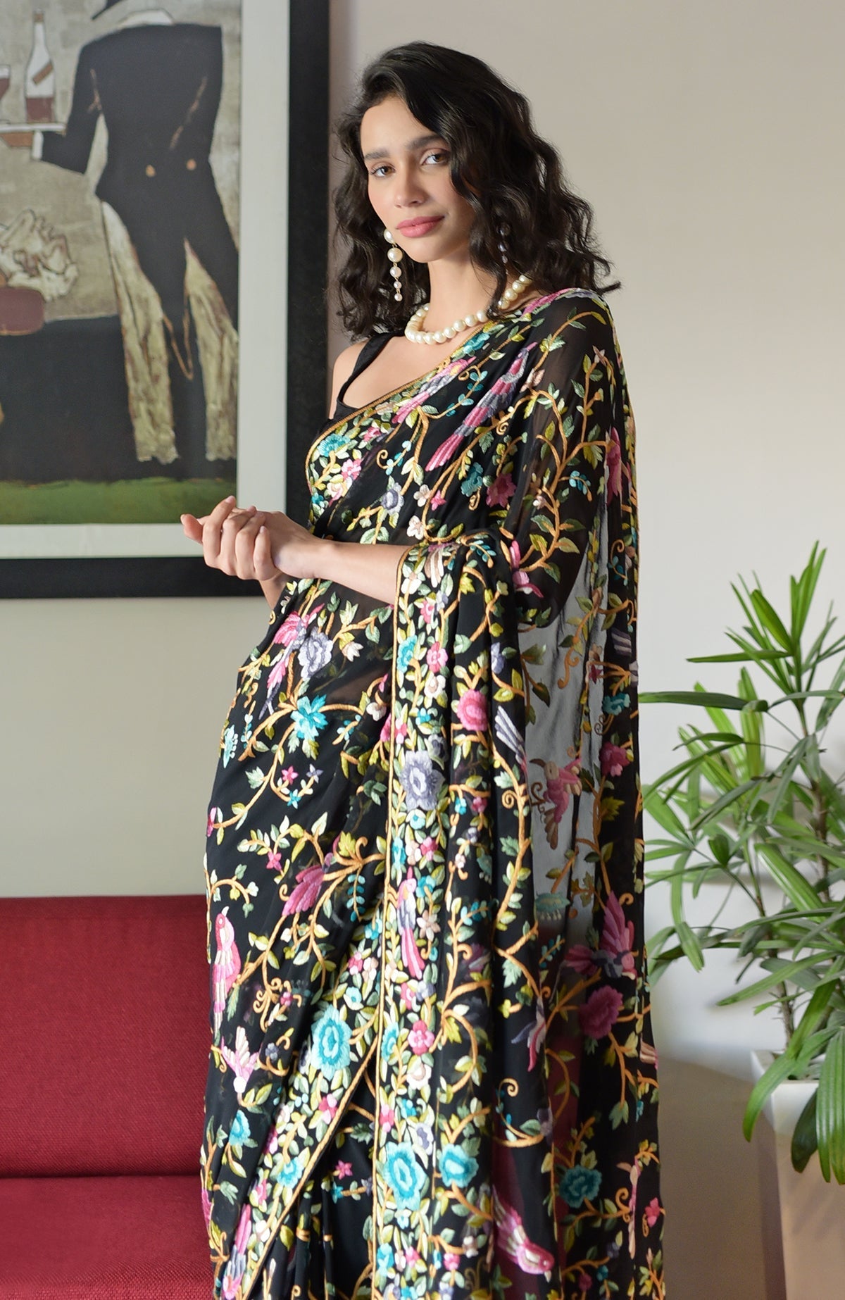 Black georgette saree with hand embroidered Parsi Gara birds and floral patterns.