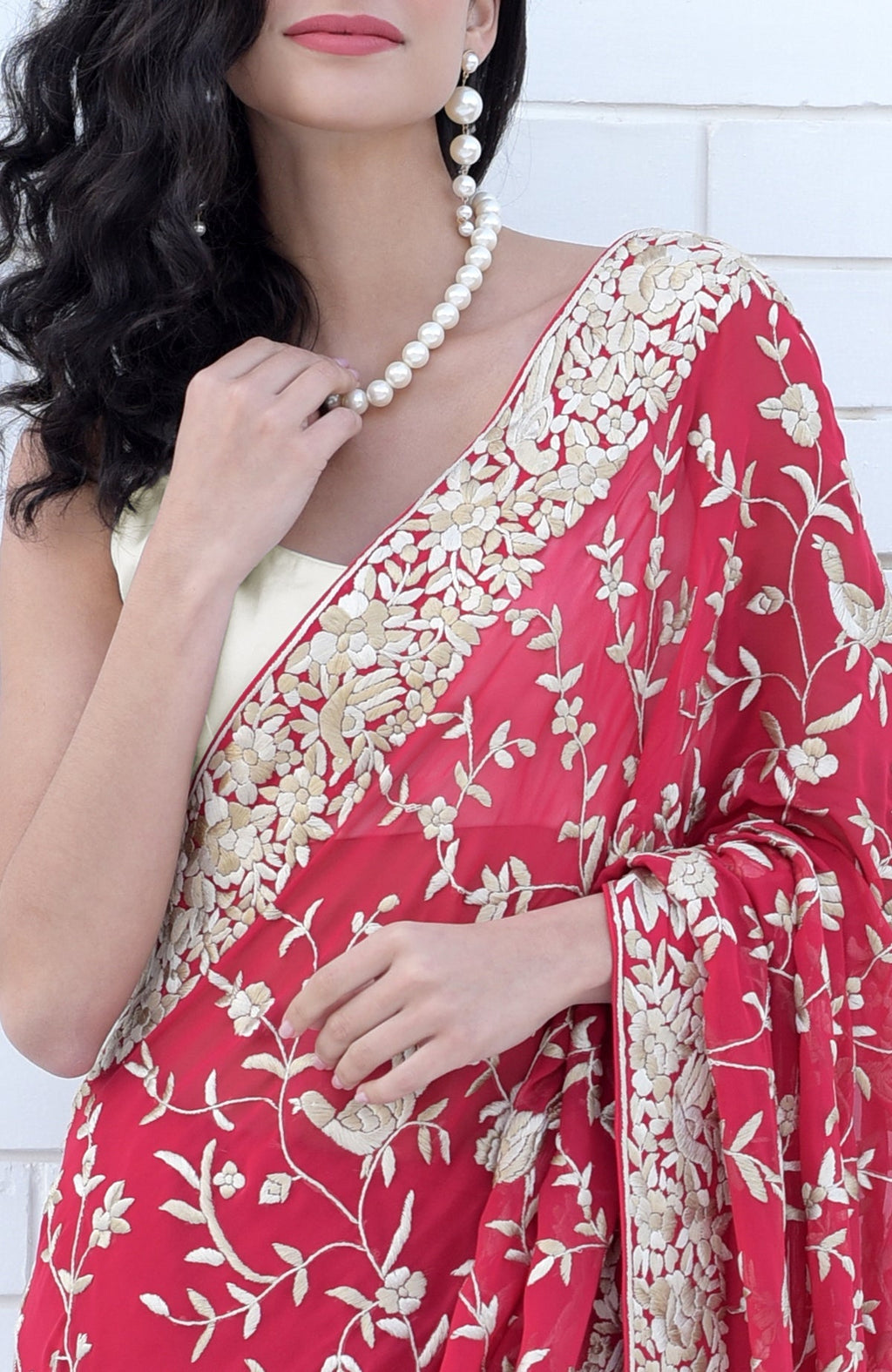 Apple red Parsi Gara saree with hand-embroidered floral and bird motifs in beige and brown.