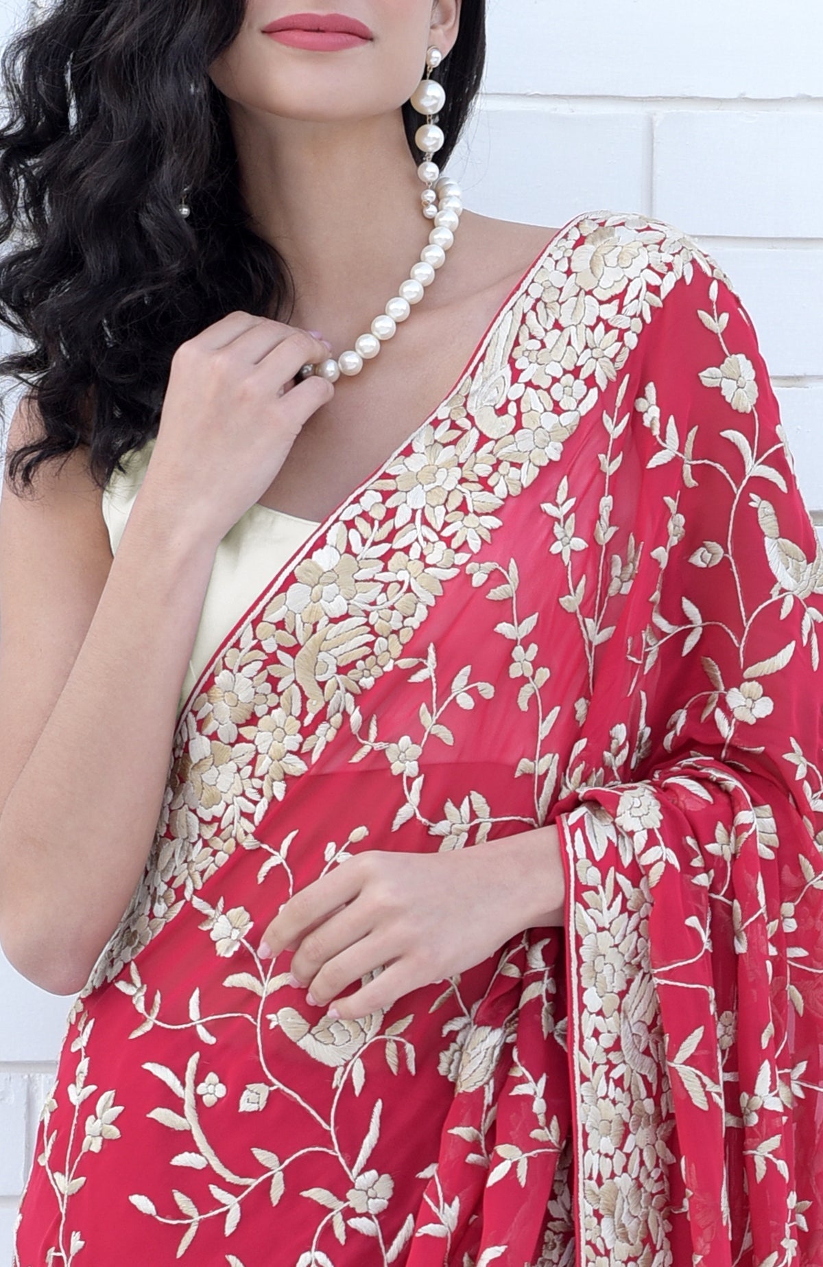 Apple red Parsi Gara saree with hand-embroidered floral and bird motifs in beige and brown.