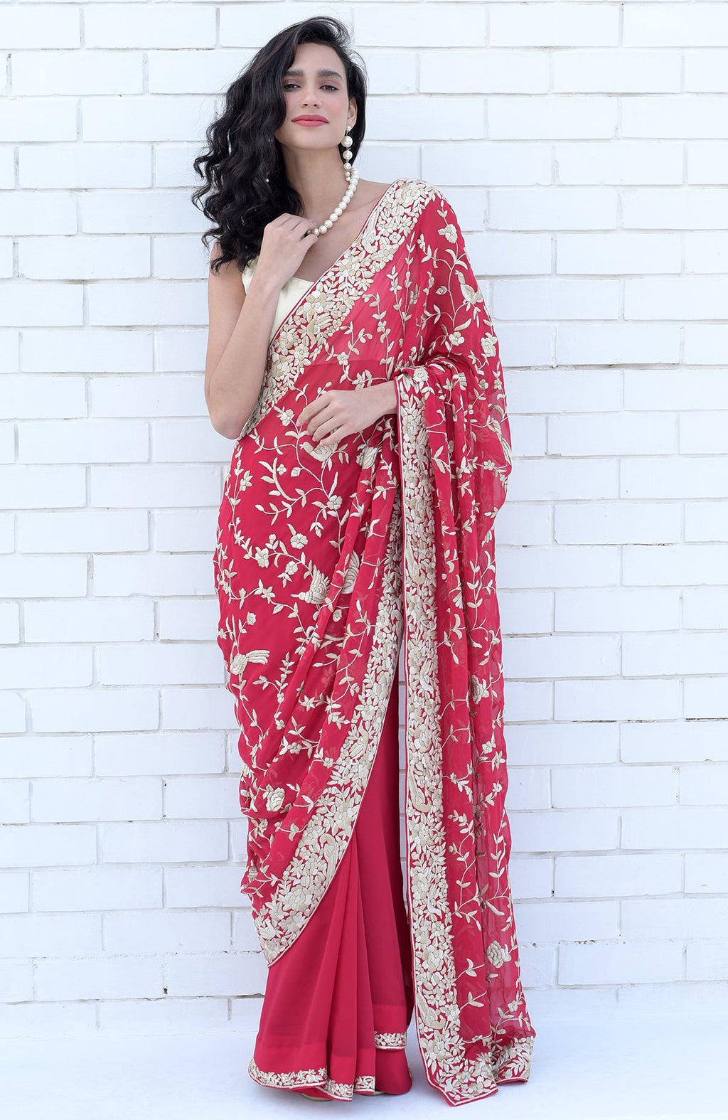 Apple red saree with hand-embroidered Parsi Gara floral and bird designs in beige and brown.