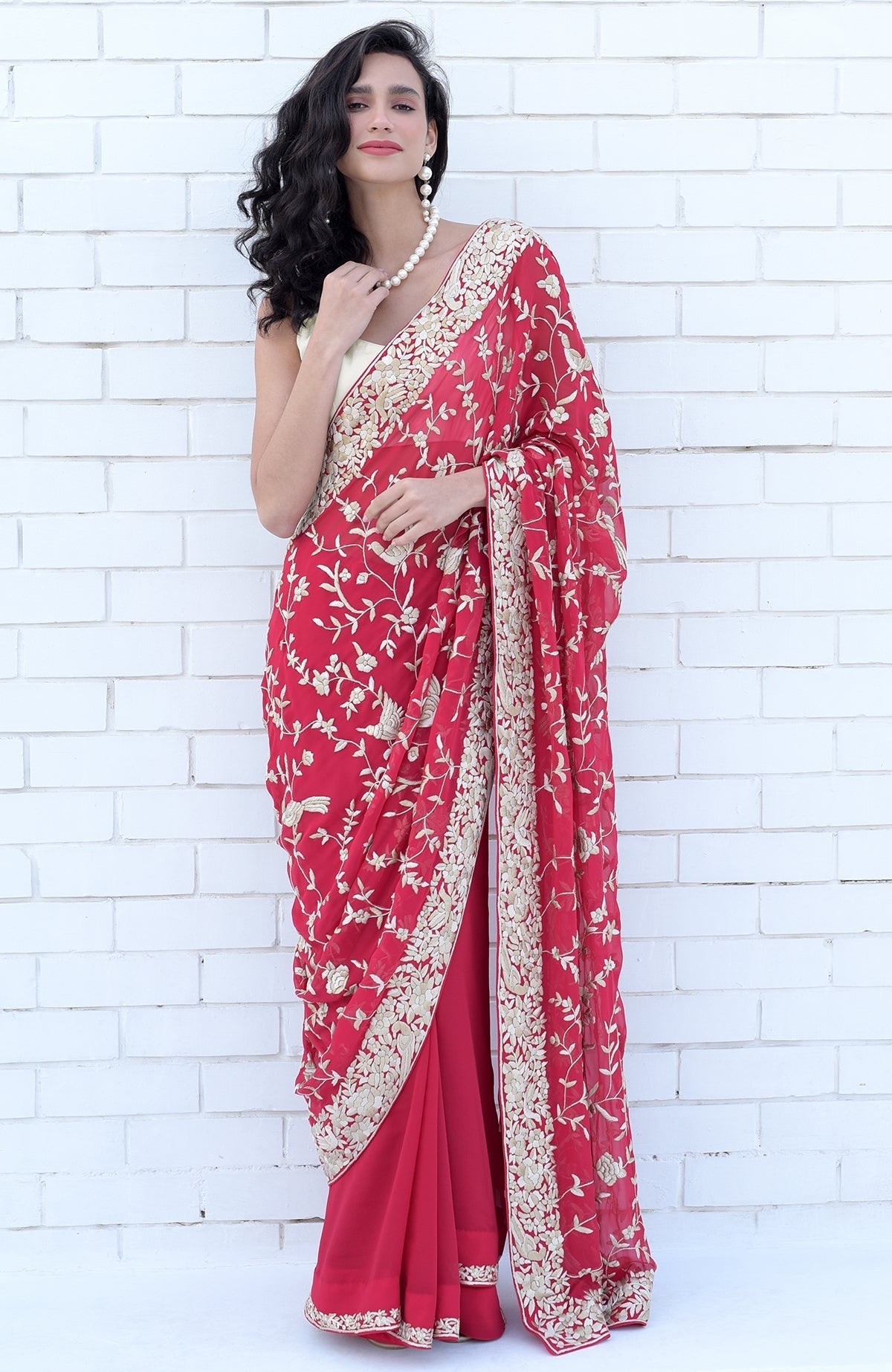 Apple red saree with hand-embroidered Parsi Gara floral and bird designs in beige and brown.