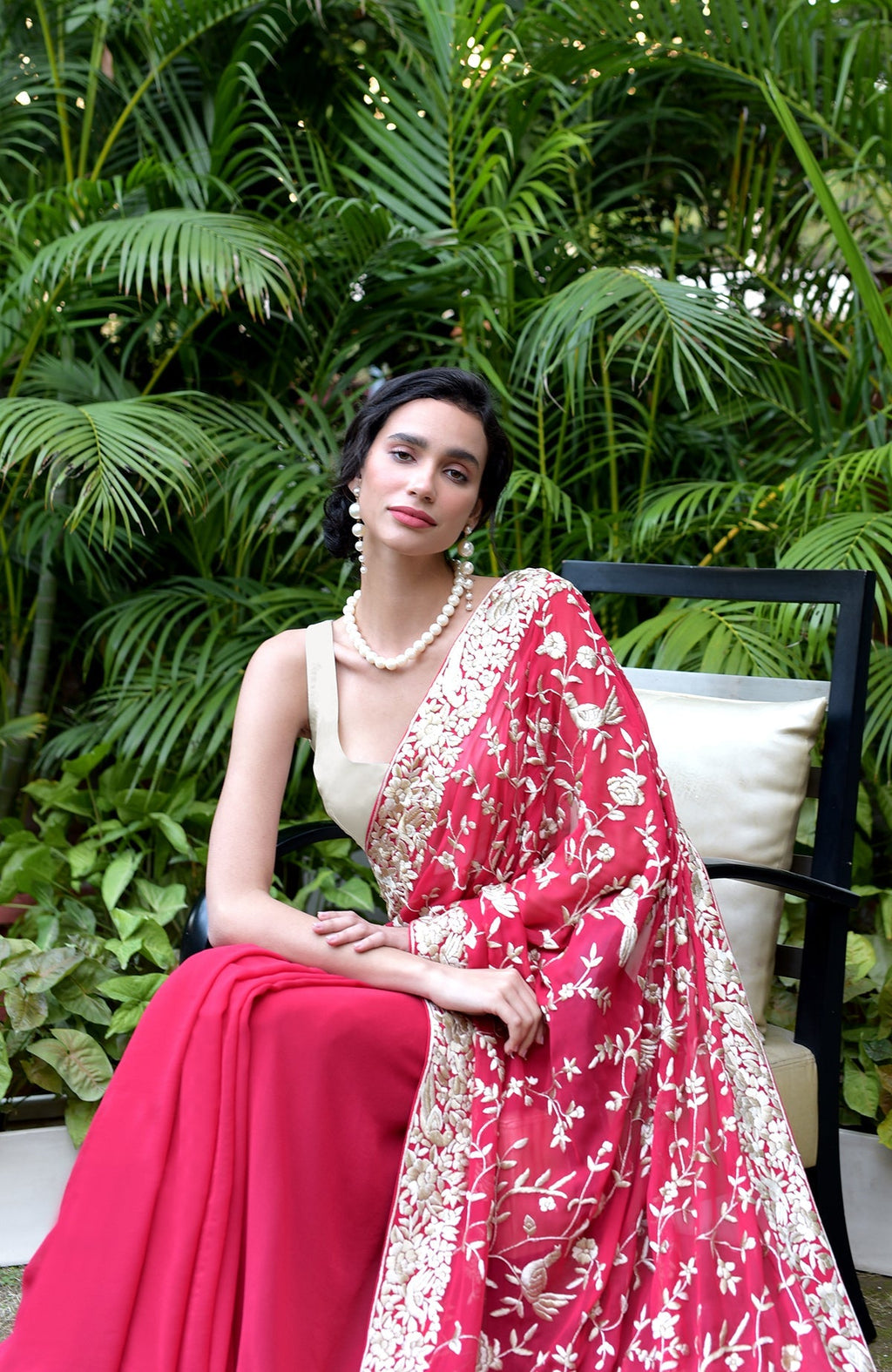 Apple red saree with hand-embroidered Parsi Gara floral and bird designs in beige and brown.