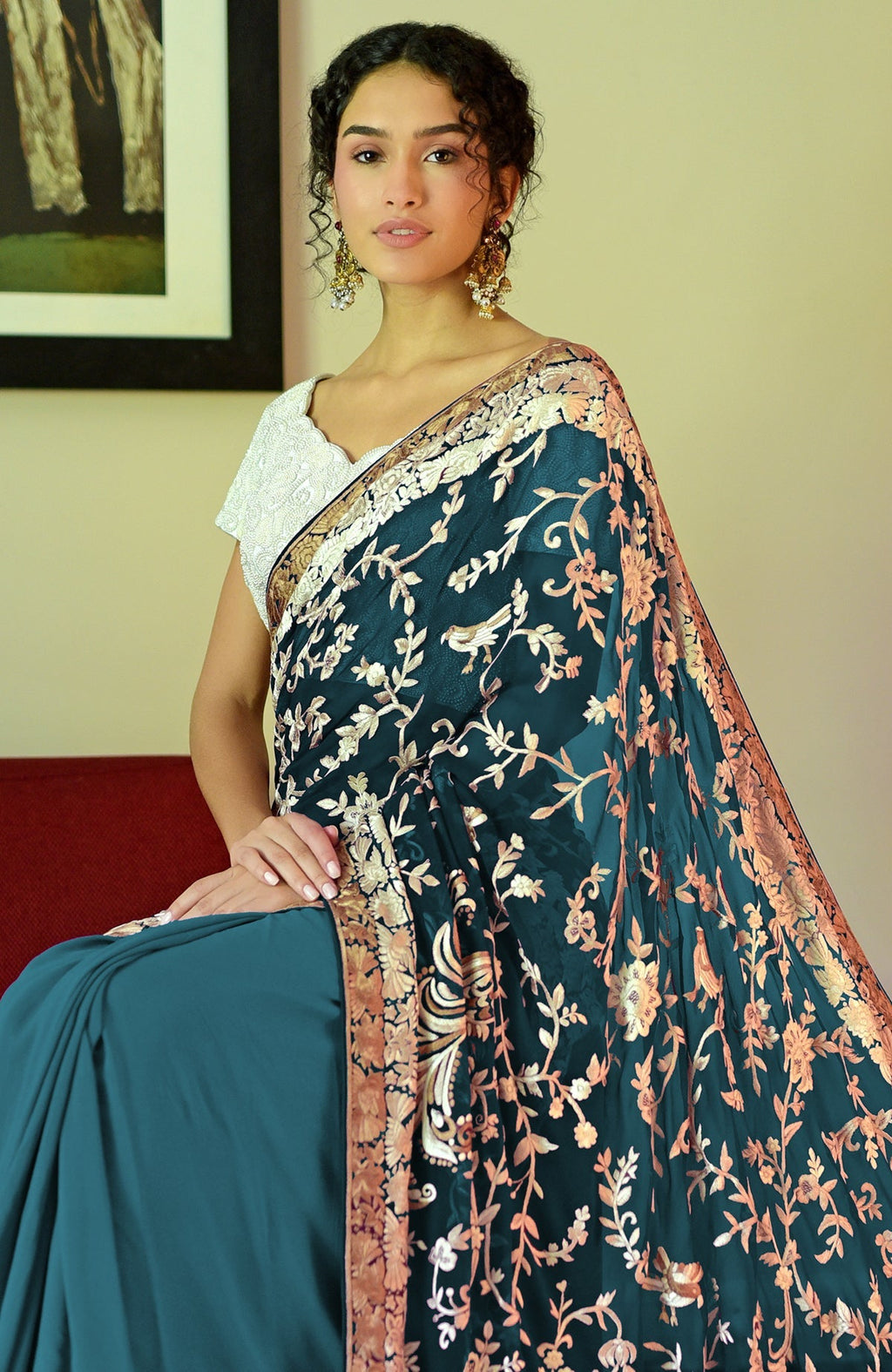 Peacock blue-teal Parsi Gara hand-embroidered saree with intricate bird and floral motifs.