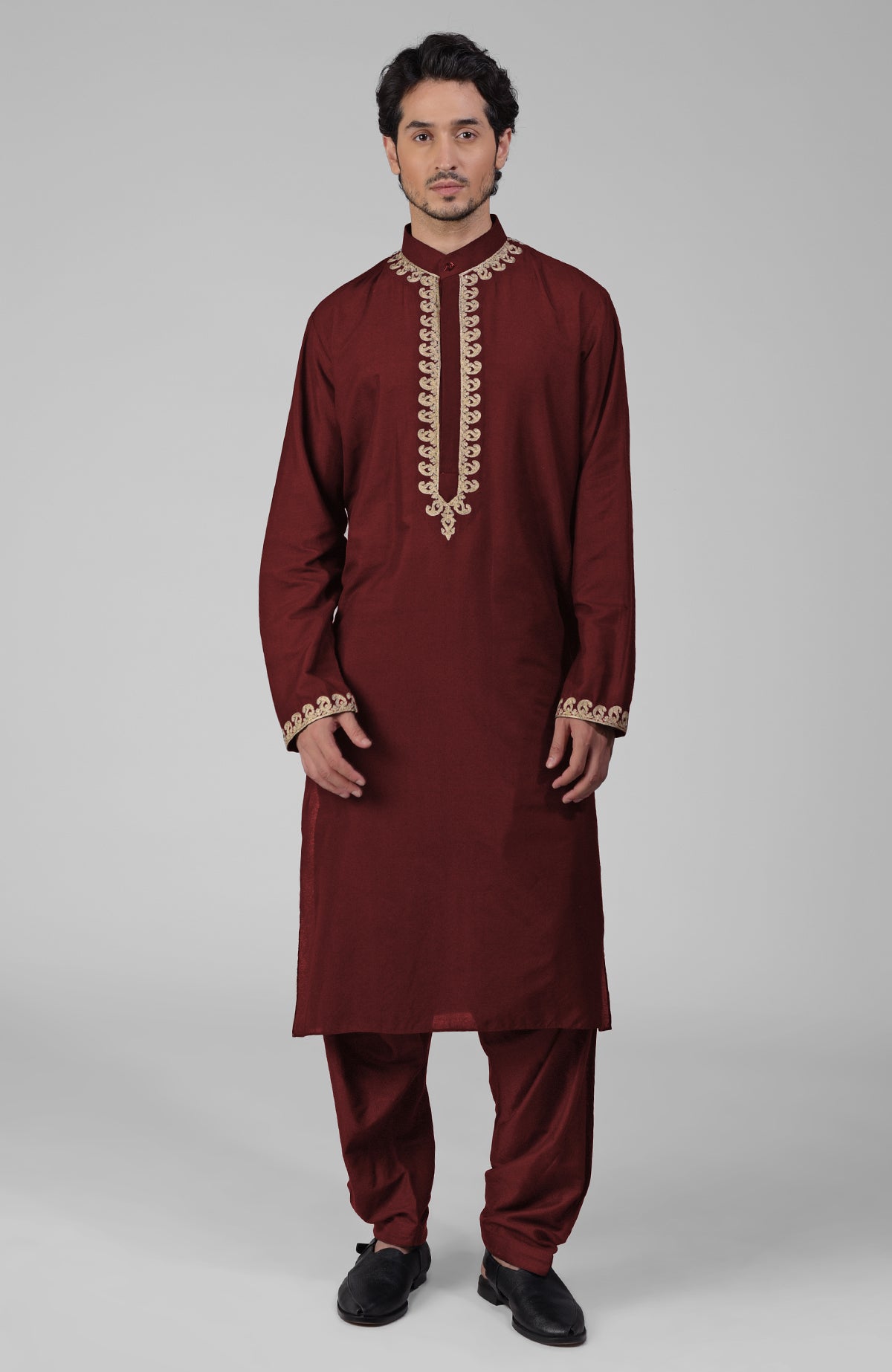 Black silk kurta with gold Kashmiri tilla embroidery paired with matching pathani salwar.