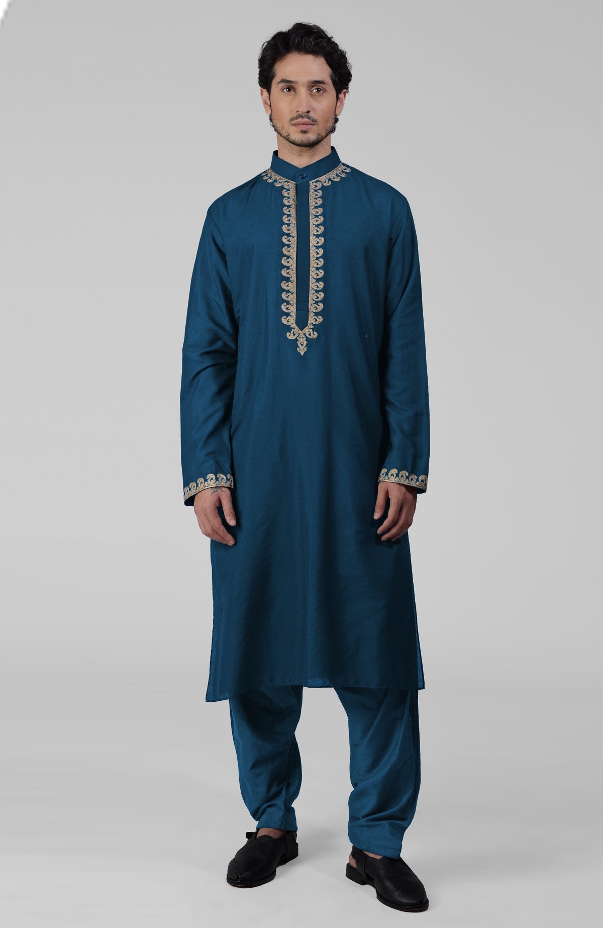 Emerald green silk kurta with gold Kashmiri tilla embroidery paired with matching pathani salwar.