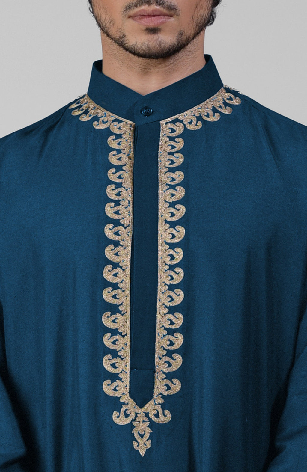 Teal silk kurta with gold Kashmiri tilla embroidery paired with matching pathani salwar.