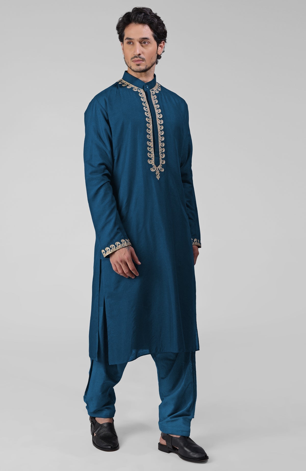 Teal silk kurta with gold Kashmiri tilla embroidery paired with matching pathani salwar.