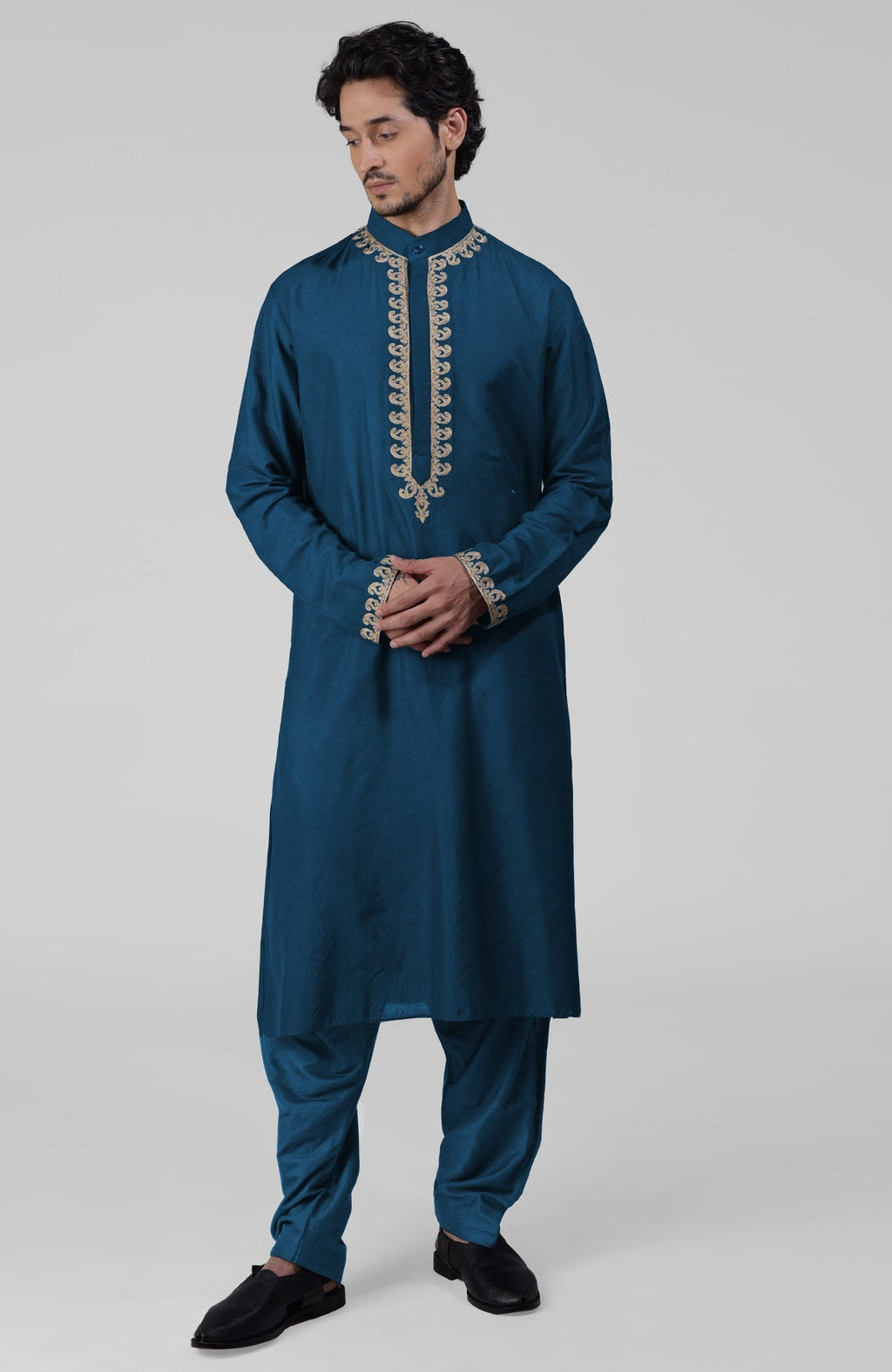 Teal silk kurta with gold Kashmiri tilla embroidery paired with matching pathani salwar.