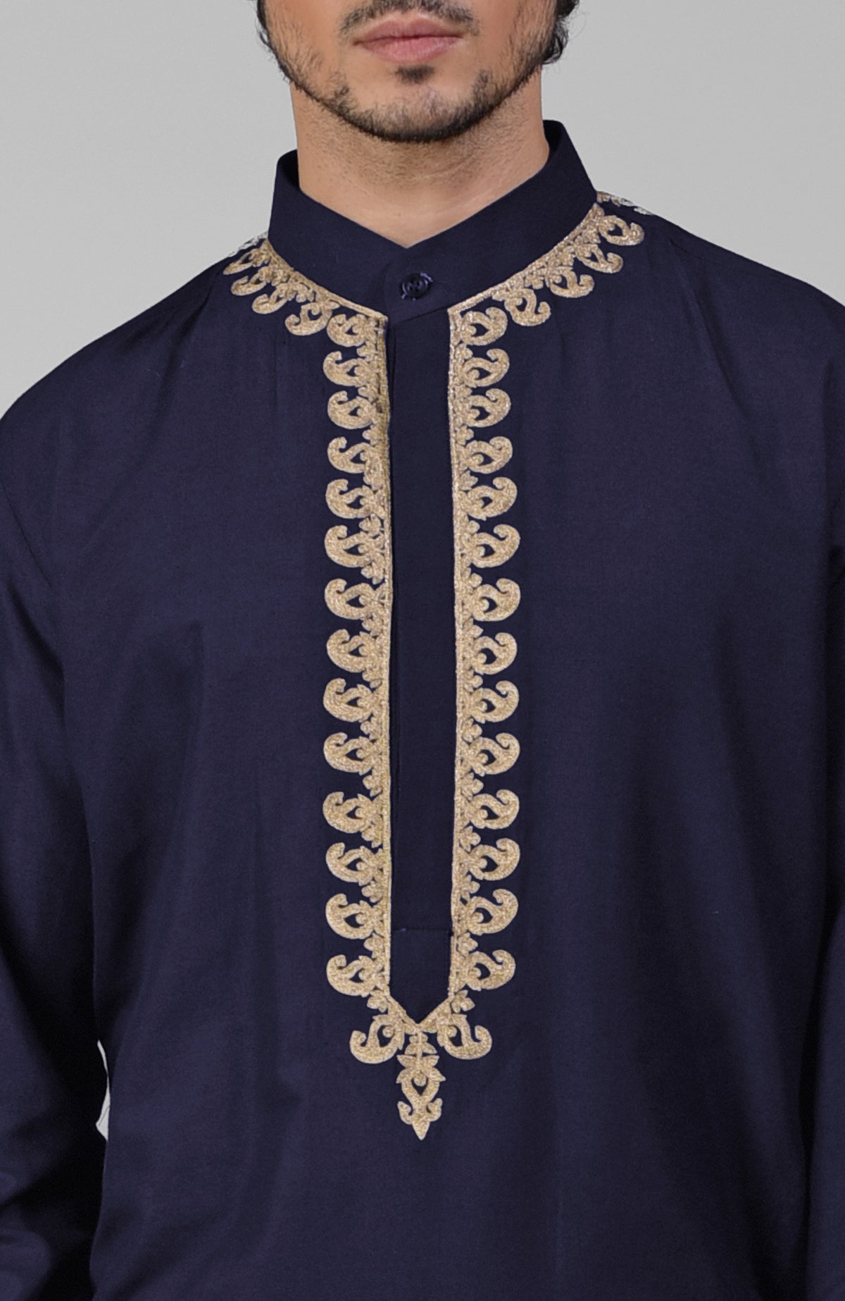 Navy blue silk kurta with gold Kashmiri tilla embroidery paired with matching pathani salwar.